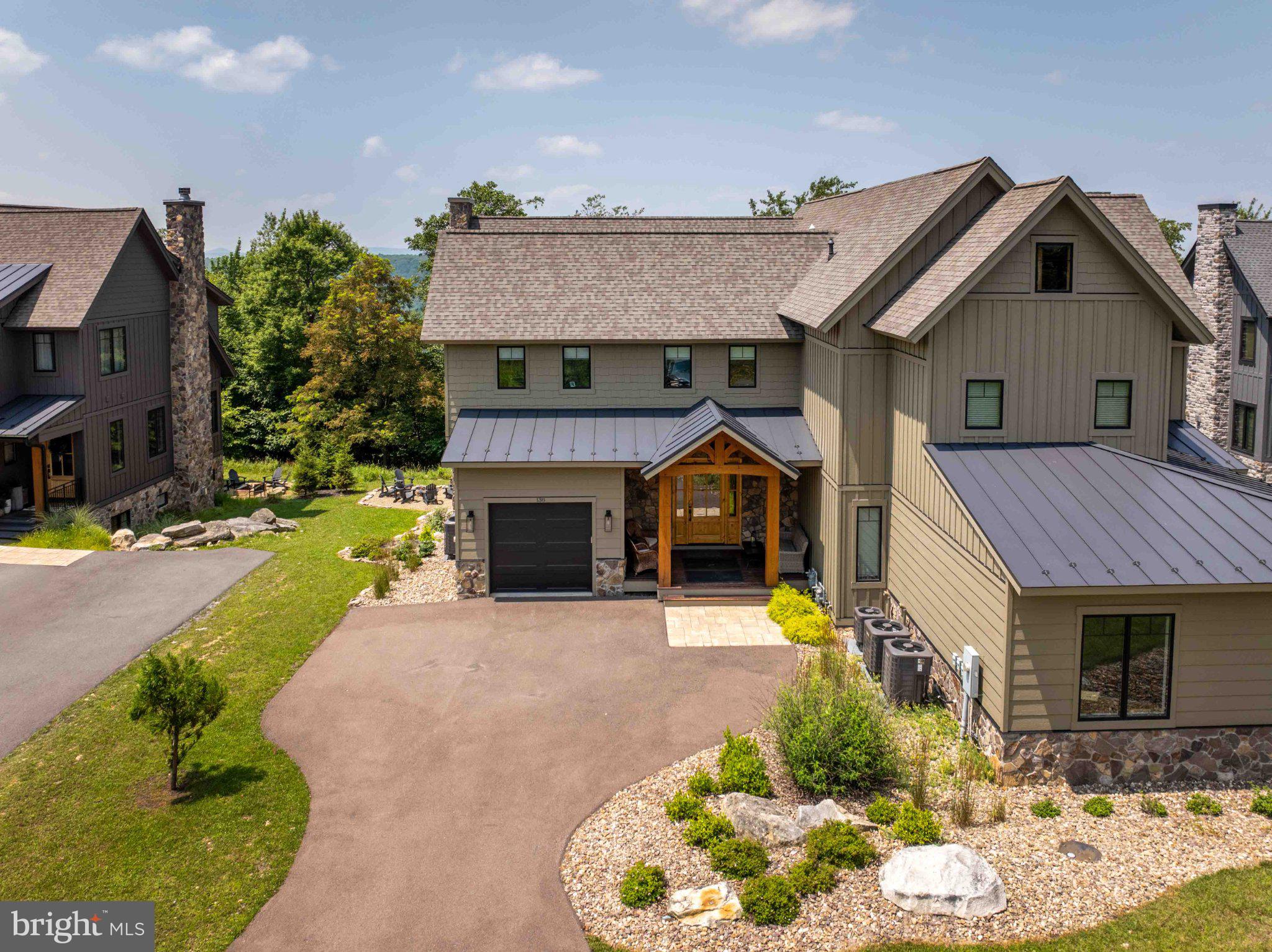 Ski access home! Perched atop Wisp Mountain in the highly sought-after North Camp community, this exceptional ski-in/ski-out home offers unbeatable access to the slopes, with Chair #7 just steps from your door.
Spanning over 4,100 square feet across three spacious levels, this beautifully designed home features 6 bedrooms and 5 ½ baths, providing ample room for family gatherings, vacation guests, or year-round enjoyment. The open-concept floor plan is highlighted by soaring ceilings, expansive windows that flood the home with natural light, and a gourmet kitchen complete with premium finishes and a large center island that's perfect for entertaining. The spacious third-level primary suite offers a private retreat with its own deck, creating the perfect place to enjoy your morning coffee or unwind while taking in the fresh mountain air. Step outside to the covered deck or patio and take in the peaceful mountain setting year-round. After a day on the slopes, unwind in the private hot tub or gather around the impressive outdoor fire pit to create lasting memories under the stars. Located just minutes from all the year-round recreation that makes Deep Creek Lake a premier destination, you'll enjoy easy access to the lake's boating, fishing, swimming, and waterfront activities, as well as minutes from the Lodestone Golf Course, scenic hiking and biking trails, restaurants, shopping, and endless outdoor adventures. Whether you're looking for a full-time mountain residence or an unforgettable vacation home, Mountain Mindset delivers the perfect combination of luxury, comfort, and four-season recreation in one of Deep Creek Lake's most desirable communities.