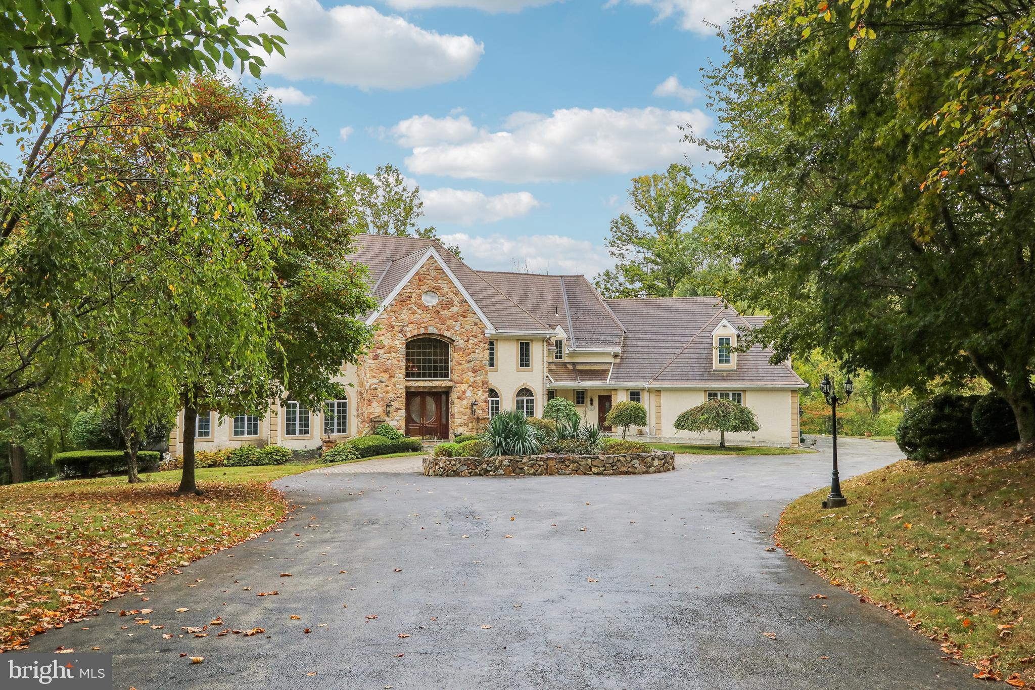 Welcome home to 6007 Goshen Rd- a custom built, beautiful property on a 5+ acre lot in the heart of Radnor Hunt and top rated Great Valley School District. This 5 bedroom, 6.1 bathroom home exudes elegance from the second you enter through the gated driveway. Offering hardwood flooring throughout the first and second levels; 10 ft ceilings on the first floor; a grand foyer with marble flooring imported from Greece; an expansive formal living room with gas fireplace and walls of windows for natural sunlight; and a formal dining room with swinging door to a butler’s pantry offering tons of counter and cabinet space and an additional fridge. Off of these areas is a gourmet kitchen with commercial grade appliances and island seating; a breakfast area for casual dining; a family room with floor to ceiling stone fireplace and built-in entertainment center; sitting area with built-in bar; and a formal office with a built-in bookcase wall. This floor is completed with 2 powder rooms and a mudroom area with back staircase. The second floor offers a magnificent primary suite with sitting area with gas fireplace, huge walk-in closet with organizational system, and a luxurious bathroom with dual vanities, stall shower, and soaking tub. Two of the bedrooms are ensuite offering private bathrooms while other two share a bathroom- all 4 bedrooms have walk-in closets. The lower walk-out level is also finished and offers tons of extra living space in addition to a built-in porch with hot tub for year round usage and a bonus room that could be used as a bedroom since there is a closet and attached bathroom. All of this plus a 3 car attached garage; flat rear yard that is completely private; and an  unbelievable outdoor living space with a flagstone deck off the entire back of the house and a flagstone patio underneath with slow cooker grill. This property is in a fantastic location- close to all major roadways for an easy commute to Philadelphia, Wilmington, and NYC; minutes to Malvern Borough, downtown Wayne, and the dining of Ellis Preserve; and central to come of the best private schools in the country- Episcopal Academy, Malvern Prep, the Agnes Irwin School, and the Haverford School. Call today to see this magnificent property; it truly is one-of-a-kind!