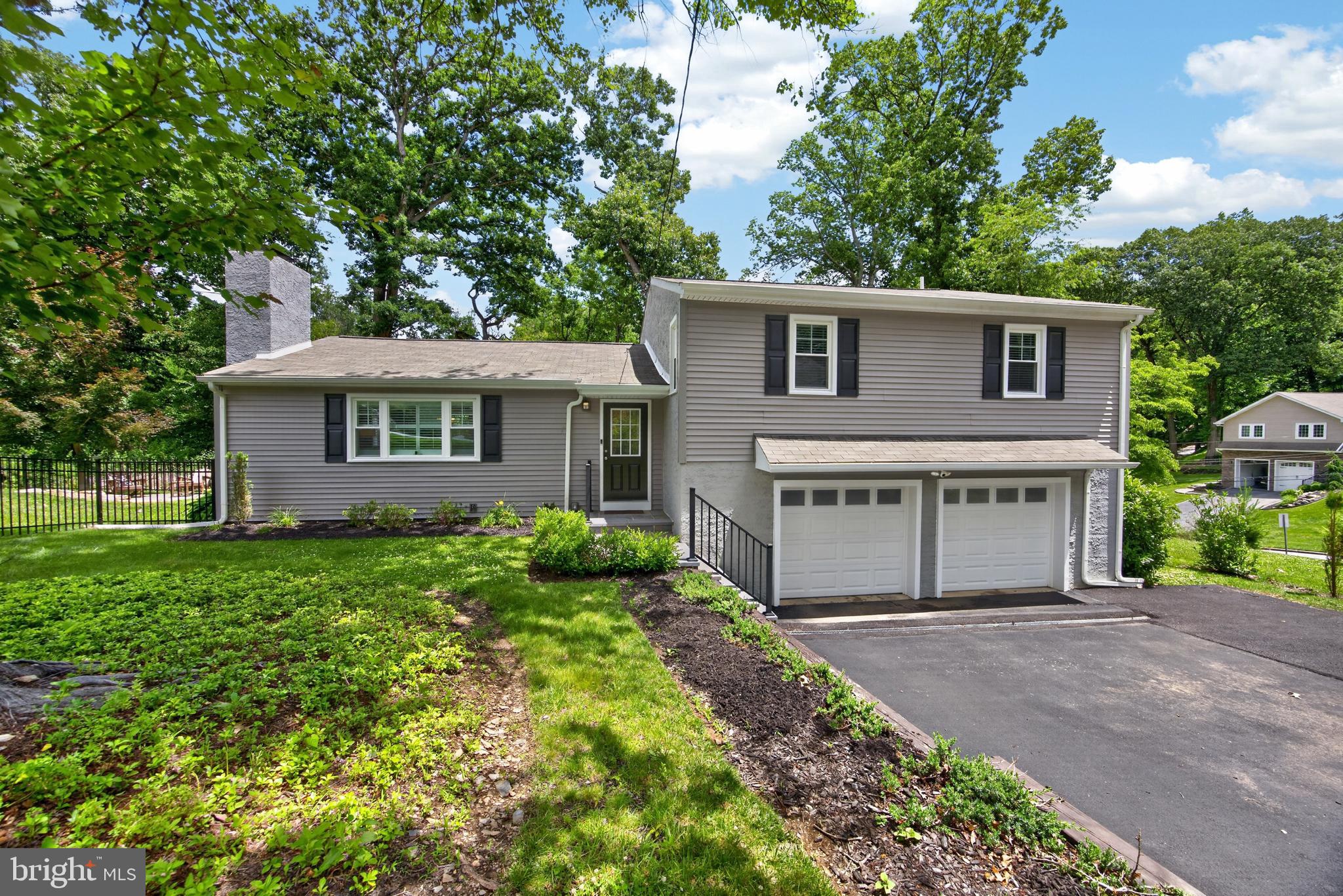 Wow!  This move-in ready home is sure to please the most discerning buyer!  Remodeled in 2023, there is nothing to do but enjoy this tastefully appointed home with neutral decor.  Set on a beautiful lot on a quiet cul-de-sac street, yet very convenient (walkable) to the train, acclaimed TE schools, shopping, parks, restaurants.  You are welcomed into the foyer and immediately notice the open first floor with gleaming hardwood floors.  The expansive living room has large windows and a wood burning fireplace.  The gourmet kitchen has an island, loads of cabinetry, an adjacent dining room with access to the fenced in side yard.  The side yard has new plantings, a new flagstone patio perfect for sipping coffee and listening to the birds. The lower level den is huge and also has large windows and an outside entrance to the covered porch, another great area to relax or entertain.  Also on this level is a laundry room, powder room and garage access.  Upstairs you will be thrilled to see the primary suite with deck access, walk-in closet and en suite bath with gorgeous basketweave marble flooring, double vanity and walk in shower.  Two additional very generously sized bedrooms with ample closet space and a full bath with penny tile flooring complete this floor.  From the oversized garage there are steps to the basement which can be used as an exercise/hobby/workshop area, very unique to a split level home.  There is 2 zone HVAC new in 2022, new hot water heater in 2025, 200 amp electric, additional insulation, LED lighting and plenty of storage.  Available for quick delivery! Open House Friday 6/19 4-6PM, Showings begin at the open house.