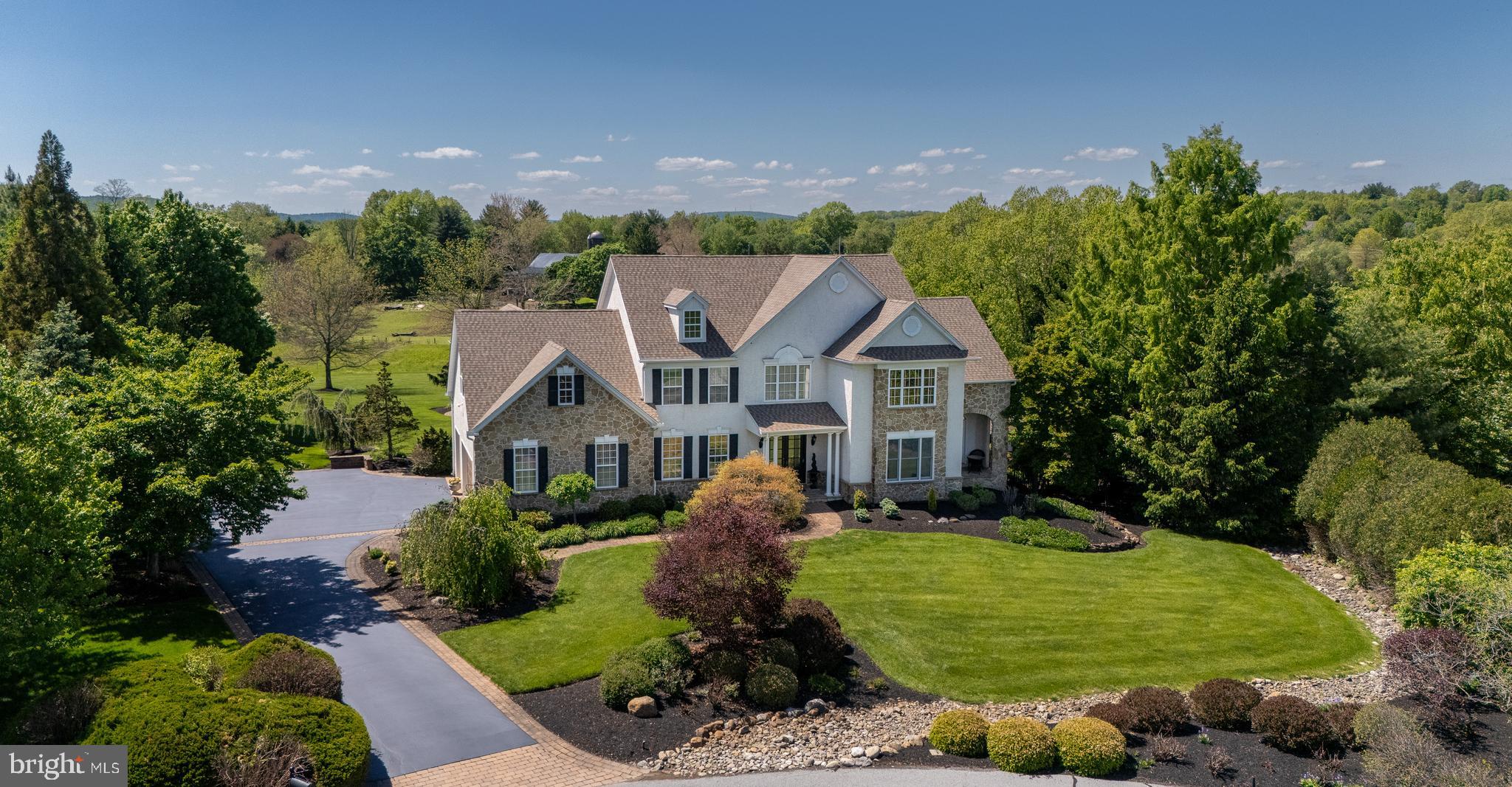 Main Line sophistication meets Chester County charm in this truly one-of-a-kind residence, nestled within the coveted Kimberton Hunt community. Set on over one acre and surrounded by open space, this home offers a rare blend of privacy, luxury, and thoughtful design where every detail has been curated to elevate both everyday living and unforgettable entertaining.

From the moment you enter, you will notice the difference. Designer finishes and custom upgrades flow throughout the home, including intricate trim work, heated flooring, bespoke window treatments, and elegant faux painting. Every room has been intentionally designed, creating a seamless balance of warmth, sophistication, and comfort.

At the heart of the home, a chef’s kitchen awaits featuring a Wolf range, Sub Zero refrigeration, and dedicated wine fridges. It is perfectly suited for both intimate family meals and large gatherings. The adjacent family room, anchored by a fireplace, opens effortlessly to the kitchen. A formal dining room and casual buffet space provide versatile entertaining options. A richly appointed wood paneled living room with a copper ceiling and fireplace offers a striking yet inviting retreat. It is complimented by a bonus sunroom or office with a covered porch. The mudroom with an available laundry closet is thoughtfully positioned on the main floor to support seamless indoor-outdoor living and easy access to the backyard.

Upstairs, a dual entry staircase from both the kitchen and foyer leads to a private sanctuary. The primary suite is a true escape. It features a serene sitting room ideal for an office or dressing space, custom finishes, expansive closet space, and a spa inspired wet room with shower and air jet soaking tub. A private guest suite includes its own bathroom. Three additional bedrooms share a beautifully appointed bathroom suite with a steam shower. A generously sized laundry room with two washers and two dryers adds convenience to the upper level.

The experience continues on the fully finished lower level. It is an entertainer’s dream. Enjoy movie nights in the media area. Gather in the conversation space or recharge in the fitness room. A full bath offers easy access from both the interior and the backyard through the walkout.

Step outside and discover what truly sets this home apart. The backyard is nothing short of a private resort. It features a custom saltwater pool and spa, stunning hardscaping, and meticulously curated landscaping that creates a tranquil, sanctuary like setting. The fully equipped outdoor kitchen includes a Lynx grill, dual refrigerators, a sink, and multiple TVs. It is the ultimate destination for hosting memorable gatherings, from relaxed summer afternoons by the pool to lively evenings with friends and family enjoying dinner and conversation under the stars. A covered deck, accessible from both the kitchen and mudroom, offers the perfect vantage point to take in breathtaking sunsets you will never want to leave.

This is more than a home. It is a lifestyle. A rare opportunity to own a property where luxury, comfort, and natural beauty come together in perfect harmony.