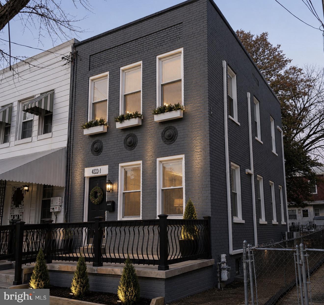Exquisitely renovated end-unit townhome offering  3 finished level , sophisticated living in sought-after Brightwood. From the moment you arrive, the new flagstone stairs and walkway lead to a spacious covered front porch that sets an elegant tone, complemented by a beautifully refinished front door. Inside, thoughtful design and quality craftsmanship shine throughout. The chef-inspired kitchen features premium "Forevermark" cabinetry in a timeless shaker style, stainless-steel appliances, and refined finishes that blend beauty with functionality. Hardwood floors and recessed lighting enhance the home’s warm yet modern aesthetic. A screened-in porch offers a peaceful retreat, while the walkout lower level with full bath and private entrance. Main-level laundry includes a high-end washer and dryer for everyday convenience. The private, fully fenced yard and secure off-street parking add rare and valuable amenities. Recent upgrades — including a roof less than two years old, brand-new HVAC system, and new water heater — offer both luxury and peace of mind. A truly turnkey residence combining style, comfort, and long-term value.