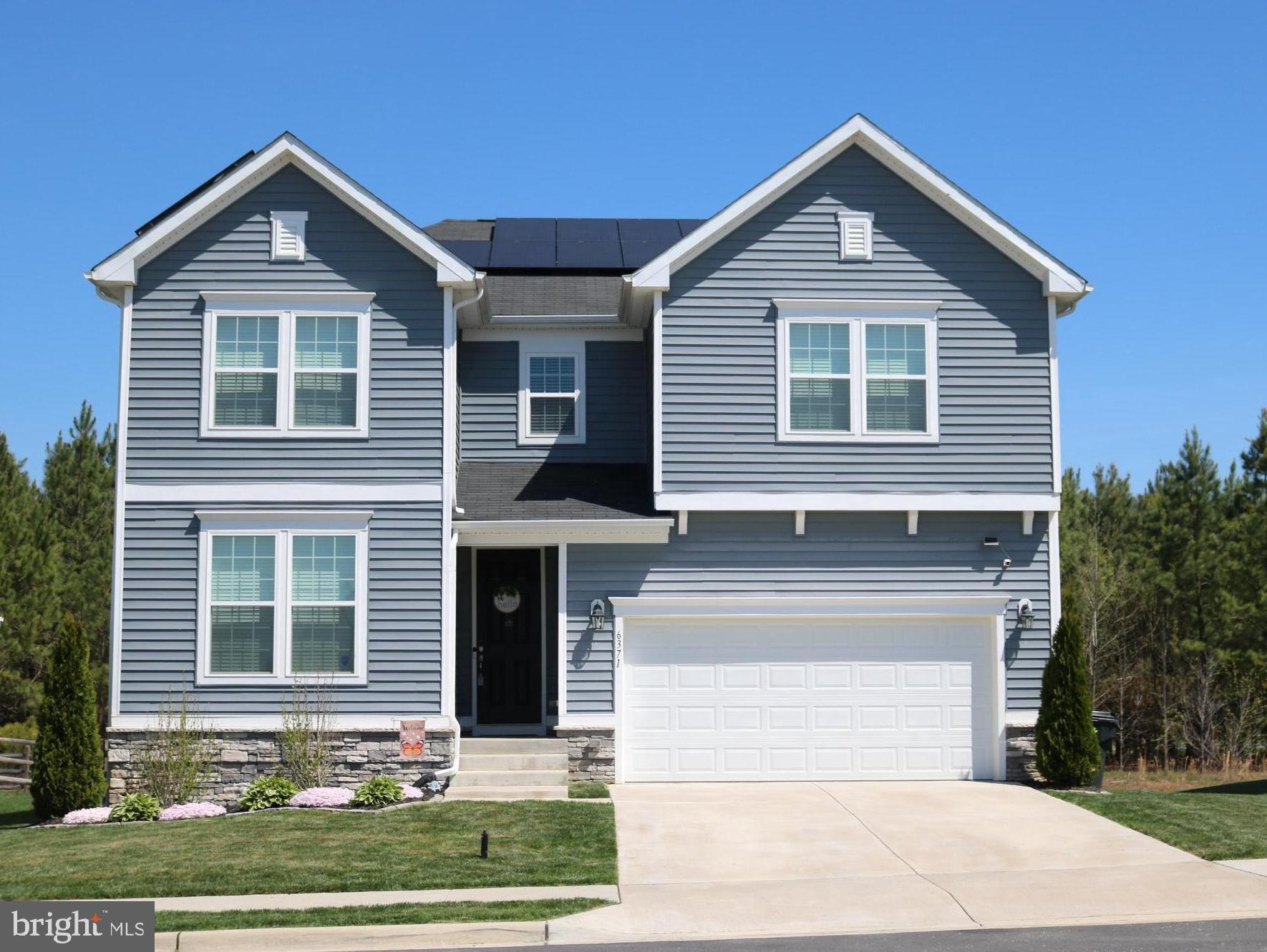 Fantastic well-maintained home with an abundance of built-in savings provided with solar panels in Hopyard Farm offering affordability without sacrificing quality! Water and electric bills for the last 12 months available for review (speak with your agent for access). Convenient to Dahlgren Naval Base, this home features an incredibly spacious floor plan (the largest currently on the market in Hopyard!) with over 3500 finished square feet, 9-foot ceilings and 8-foot doors on the main level, 9-foot ceilings in the finished basement, a private office space, seamless flow from family room to kitchen which boasts a huge walk-in pantry with wood shelving, granite countertops, and stainless appliances, great primary bedroom with a very large walk-in closet, 4 additional spacious bedrooms (2 of which also have walk-in closets!), 3.5 bathrooms (all with quartz countertops and ceramic tile), and a convenient upper-level extra-large laundry room with plenty of space for folding table, storage, or other extras! The layout is designed for both relaxation and entertaining. Step outside onto your beautiful maintenance-free deck overlooking a wonderful level fenced-in yard that backs to trees and a walking path, perfect for morning coffee or evening gatherings. Govee permanent lighting included with sale! Don't let this one slip away!