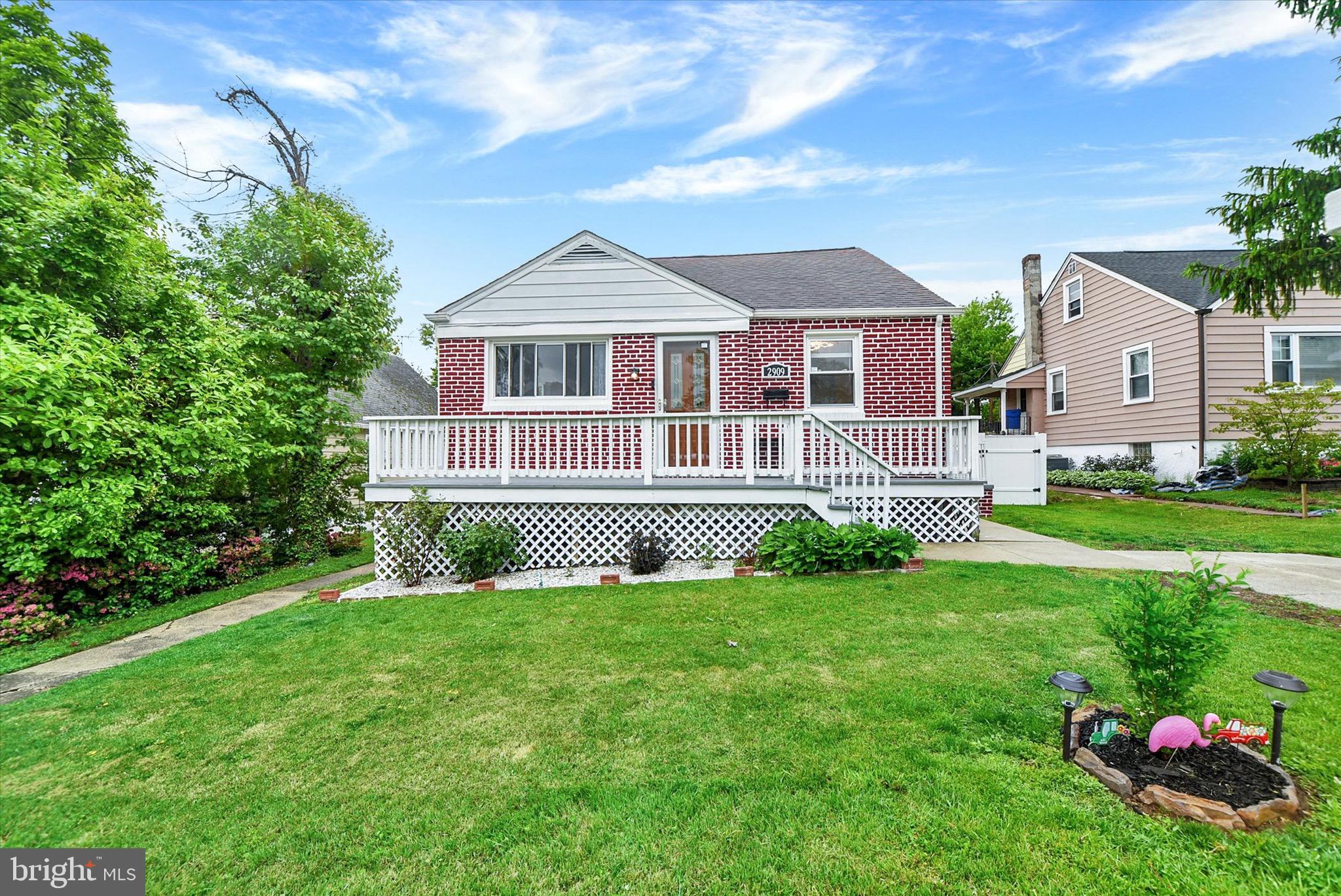 Welcome home to this charming brick Cape Cod that blends warmth, functionality, and space in all the right ways. Begin your tour on the inviting front porch—perfect for morning coffee—before stepping inside to a freshly painted interior where gleaming hardwood floors carry throughout the main level. The spacious living room is filled with natural light and flows effortlessly into a layout designed for flexibility, offering two main-level bedrooms and a full bath—ideal for convenient one-level living.

Upstairs, you’ll find a true retreat in the private primary suite, featuring a generously sized bedroom with cozy carpeting and its own updated full bath, creating a quiet escape from the rest of the home.

The fully finished basement opens up even more possibilities, complete with stylish LVP flooring, a second  kitchen, updated full bath, additional bedroom, extra living space and its own exterior entrance—perfect for guests, extended living, or entertaining with ease.

Step outside and experience a backyard that truly stands out. The expansive, fully fenced yard offers endless opportunities to relax or host gatherings, highlighted by a covered patio made for cookouts and outdoor dining. A new shed provides extra storage, while the playground set and trampoline are ready for everyday fun.

With a full bathroom on every level, a private driveway, and a well-maintained interior that feels both cozy and versatile, this home delivers comfort, space, and lifestyle all in one inviting package.