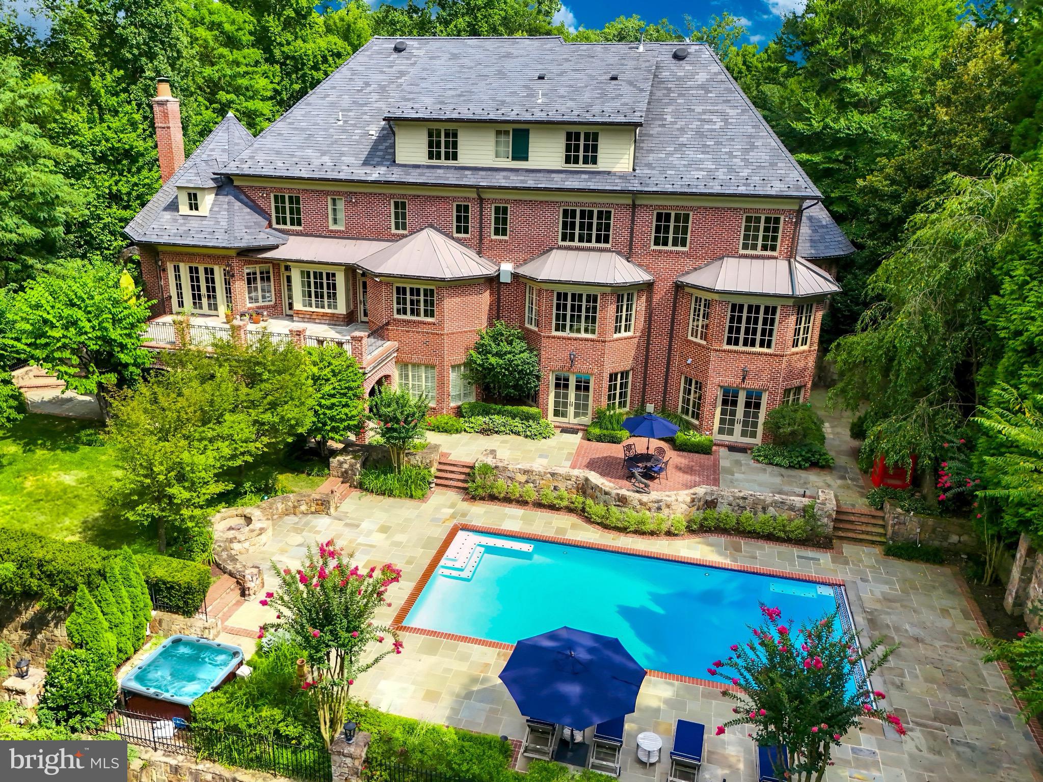 Over $700,000 price reduction—don't miss this exceptional opportunity! The Reserve stands as McLean’s most coveted residential community, featuring approximately 170 luxurious custom homes set among rolling hills, all within an exclusive guard-gated enclave. Within this distinguished enclave, set in an idyllic setting 852 Alvermar Ridge stands proudly with over 13,000 square feet of exquisite living space. The property showcases a stately paver motor court and a stacked stone facade, enhancing its impressive curb appeal. Upon entering, you are welcomed by a majestic mahogany staircase in the foyer, illustrating the home’s luxurious craftsmanship and attention to detail. The floor plan masterfully balances formal and informal living spaces, maintaining symmetry and proportion throughout. The gentleman’s library is elegantly appointed with mahogany and detailed coffered ceilings, offering a sophisticated and quiet space for reading or study. The large formal dining room is ideal for grand banquets and is seamlessly integrated into the flow of the house, ensuring a stately yet welcoming environment.

Central to the home, the kitchen features elegant cabinetry, superior stonework, and is complemented by state-of-the-art appliances. Adjacent is a bright breakfast area, providing a delightful space for morning meals and casual dining. The family room, accessible from the kitchen, offers access to the outdoor balcony, perfect for indoor/outdoor living and entertaining.

The primary suite, located in a private wing on the upper level boasts a serene sitting area, a sumptuous sleep area with picturesque views, and luxurious spa-like bathrooms with freshly renovated Calcutta marble and walk-in closets. 

The lower level is designed for entertaining, featuring a sophisticated lounge with pool access, a professionally equipped wet bar, and a climate-controlled wine cellar with a 1,500-bottle capacity. The expansive grounds are perfect for hosting, featuring a stone terrace with an impressive pool, hot tub, and meticulous landscaping. Additional luxurious amenities include a robust Cummins generator, a newly renovated $125K back deck, elegant lantern heads on the driveway columns, and a mahogany elevator servicing all four levels, all designed by Custom Design Concepts. Freshly painted interiors enhance the rich mahogany woodwork that graces each level.

The Reserve, McLean’s most exclusive residential enclave, offers unparalleled security with 24-hour patrolling and a suite of bespoke concierge services at the elegant gatehouse. Situated just minutes from Tysons Corner and the Beltway, this grand estate offers unparalleled luxury, security, and the distinguished prestige of McLean’s finest residences.