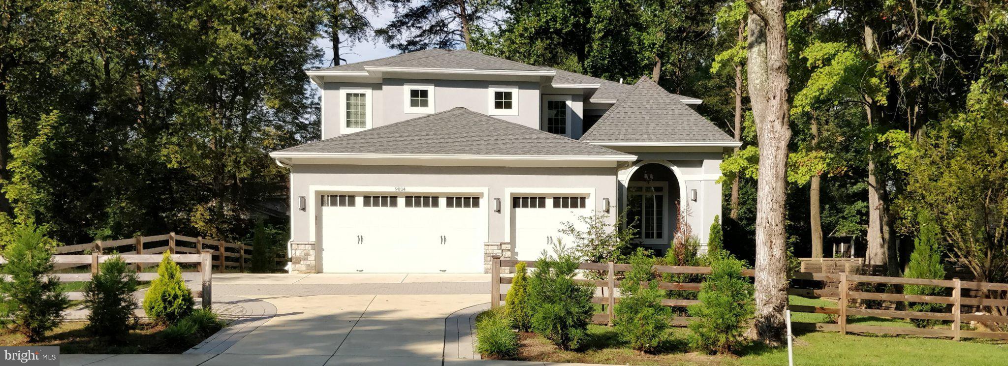 Discover a rare blend of European elegance, modern luxury, and exceptional craftsmanship in this custom-built residence completed in 2016 and situated on a beautifully landscaped quarter-acre lot with mature pine trees and a gated entry. Featuring a striking stucco façade, Italian-inspired alcove entry, and dramatic LED architectural lighting, this extraordinary home offers over three finished levels designed for both grand entertaining and comfortable everyday living. A welcoming circular driveway finished with concrete and green stone pavers leads to a highly sought-after three-car garage, a rarity in Bethesda. Inside, a dramatic two-story atrium creates a stunning first impression, while 10-foot ceilings, rich hardwood flooring, custom millwork, and premium finishes are showcased throughout the main level. The heart of the home is a gourmet Thermador chef's kitchen designed to impress, featuring professional-grade appliances, abundant cabinetry, and seamless flow into the breakfast room and expansive great room. A striking see-through gas fireplace creates warmth and ambiance between the living spaces. The adjoining butler's pantry includes a coffee bar with a built-in Wolf coffee system, making entertaining effortless. The main level also offers a private study, a bedroom with a full bath ideal for guests or multigenerational living, a spacious mudroom with additional washer/dryer hookups, and access to a large deck overlooking the beautifully landscaped grounds. The luxurious upper-level primary suite serves as a private retreat, complete with a professionally designed walk-in dressing room, private terrace, and a spa-inspired bath featuring heated floors, a heated towel rack, and premium finishes. Three additional bedrooms, two full baths, and a conveniently located second laundry room complete the upper level. Designed for entertainment and recreation, the walk-out lower level offers an expansive recreation room opening to a private patio, a home theater, exercise room, dedicated playroom, climate-controlled wine cellar, wet bar with kitchenette, and a full-sized in-law or au pair suite with a private bath. Thoughtfully designed with exceptional attention to detail and amenities rarely found at this price point, this remarkable residence combines luxury, functionality, and timeless style in one of Bethesda's most desirable locations. Conveniently located near top-rated schools, shopping, dining, parks, and major commuter routes, this is a truly exceptional opportunity to own a custom-built masterpiece.