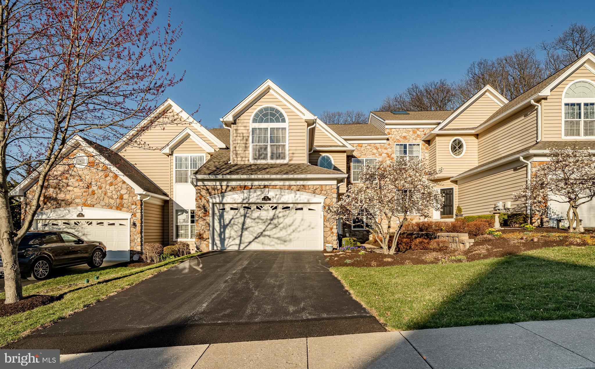 37 Sagewood Drive offers luxury living and a worry-free, maintenance-free lifestyle at its best. This luxury Carriage House is exactly what you have been looking for. Relax while the HOA takes care of the landscaping, lawn care, and exterior home maintenance, including the roof, gutters, siding, and trim. Even in the winter, you can relax while they clear snow from driveways, front walkways, sidewalks, and even the street. This home also offers natural views as it backs to mature woods. With over 2,800 square feet plus a professionally finished basement, this home offers generous living space. When you step inside the foyer, you are immediately welcomed by the Great Room, which sets the tone with a dramatic soaring cathedral ceiling and two levels of windows that create a warm and inviting gathering space. To the right of the entry is the formal dining room, adorned with fine crown molding, chair rail, wainscoting, and a tray ceiling that creates an ideal setting for elegant entertaining. What sets this home apart is the open floor plan combining a seamless family room, kitchen, and breakfast nook, filled with windows and centered around a cozy fireplace that can be enjoyed by everyone. This space leads out to the deck with views of the woods and walking/biking trail. This is a peaceful retreat. The gourmet kitchen is appointed with premium 42-inch cherry cabinets with extra millwork. There is an elegant blend of granite, tile, and marble. Be sure to notice the custom tumbled marble backsplash. All appliances are top brands. Upstairs, a balcony overlook adds charm and dimension. You will find three generous bedrooms, each with ample closet space. One bedroom has direct access to the full hall bath, which features double sinks and a linen closet, while also remaining accessible from the hallway. The primary bedroom suite offers a fireplace, huge walk-in closets and a luxurious bath with tile, a double vanity, soaking tub, and stall shower. This much-loved community, Charlestown Meadows, is considered a Gold Star community because residents are very pleased with the services the HOA provides at a reasonable cost. The neighborhood offers quiet tree-lined streets and amenities that include a lovely clubhouse, fitness center, jogging and walking trail, swimming pool, tennis courts, and tot lot. HVAC and water heater have been replaced in the last 4 years.