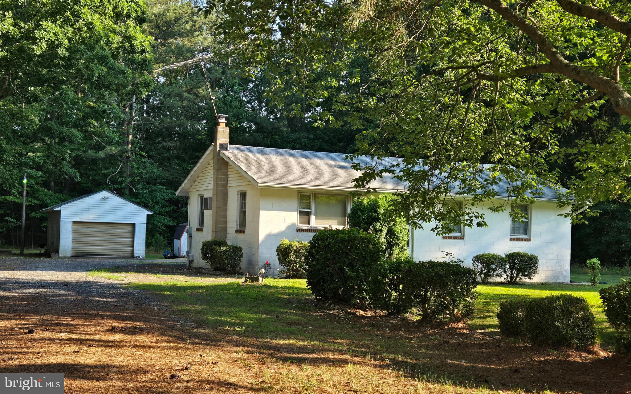 Nestled on a serene 2.17-acre lot, this charming ranch-style home offers a perfect blend of comfort and nature. Surrounded by lush trees and partly wooded areas, the property provides a tranquil retreat, ideal for those seeking peace and privacy. Imagine sipping your morning coffee while enjoying views of the garden and woods from your rear yard, where you can create your own outdoor oasis. Inside, the home features three cozy bedrooms and a full bathroom, making it a delightful space for relaxation. The detached garage and gravel driveway offer ample parking and storage options. Focus on enjoying the expansive outdoor space, perfect for gardening or simply unwinding in the fresh air. This property is a rare find, making it an inviting place to call home. Embrace the opportunity to create lasting memories in this peaceful setting, where nature and comfort come together.