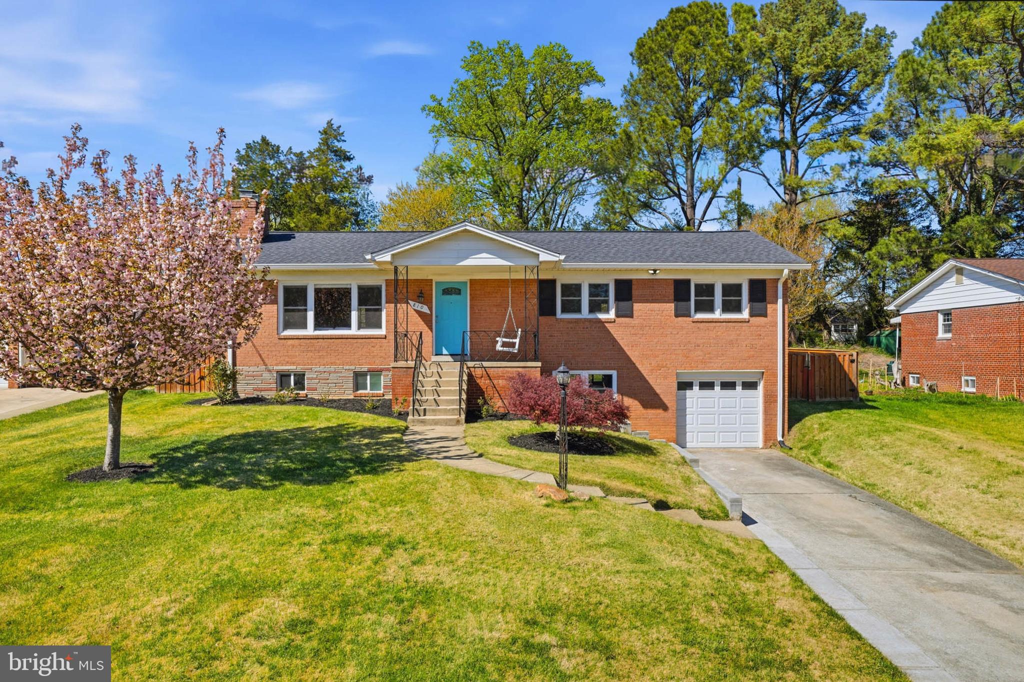 ASSUMABLE VA MORTGAGE at 4.75% interest rate ! PLEASE CALL LISTING AGENT FOR DETAILS!  PERFECTION! This stylish, four bedroom, three full bathroom rambler in sought after Springbrook Terrace checks every box! A charming front porch with relaxing swing greets guest as you enter into a a sun filled main level! An open concept living area features a spacious living room with fireplace, separate dining room, gourmet kitchen, and a large sunroom addition! The main level also holds two sizable guest rooms, an updated full bathroom, and an impressive primary suite with en-suite bathroom and walk-in closet! A finished lower level with walk-up entry to the backyard, holds a large family room, a full bathroom, laundry room,  an at home office/gym, a fourth bedroom, and plenty of storage space! An oasis-like backyard is fully fenced and holds a large storage shed, playhouse, and a patio off of the kitchen that is perfect for summertime entertainment! Enjoy an oversized  garage, a recently updated roof, recently installed siding, electrical "heavy up", updated washer/dryer, and several other attractive updates! This location offers close proximity to area schools, a variety of shopping options, several major commuter routes, and fun activities at MLK Recreational Park that include pool (indoor and outdoor), tennis, and playgroud ! Come quickly!
