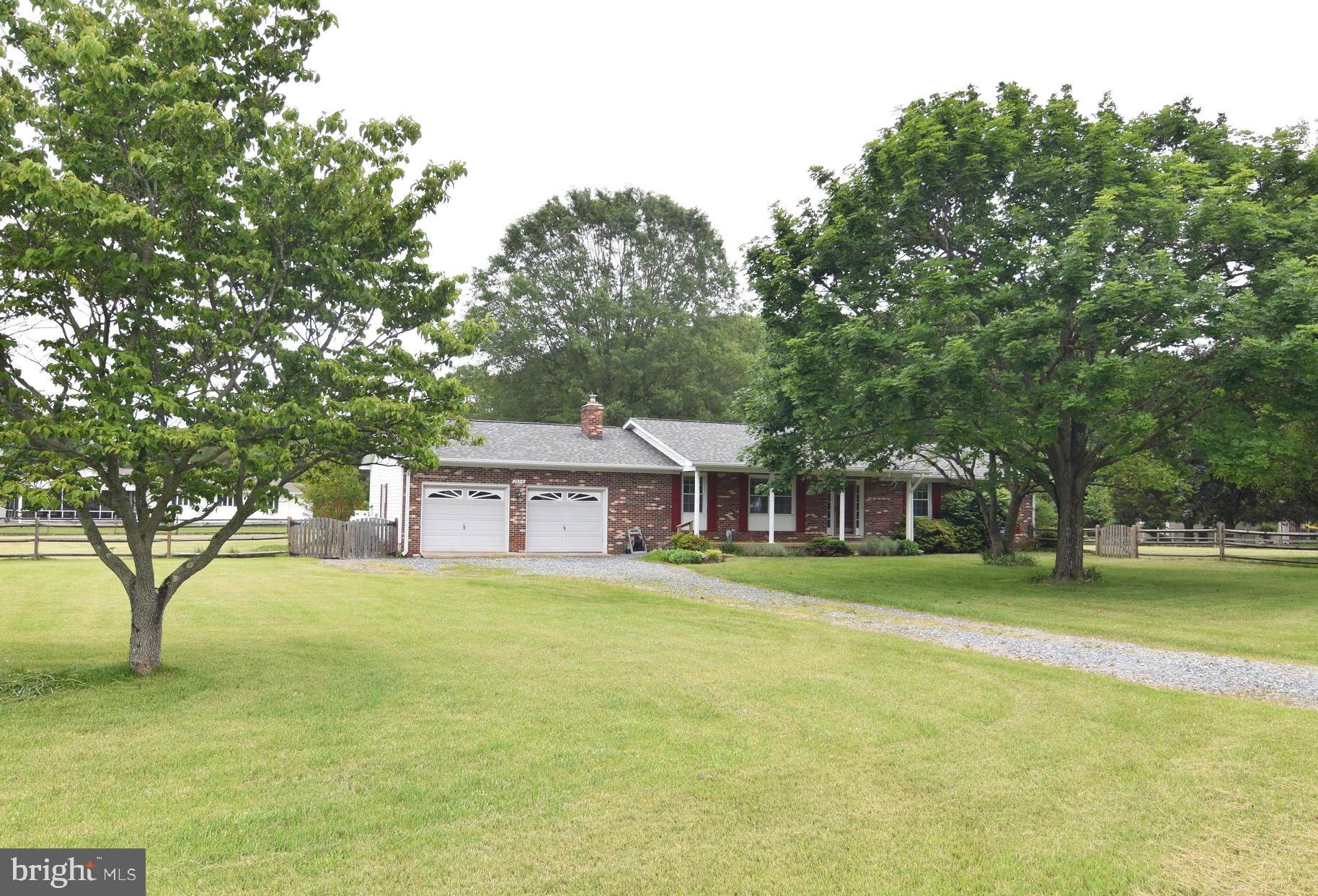 Well cared for rambler on beautiful lot.  Open floor plan, hardwood floors, updated kitchen with granite, gas stove, breakfast bar.  Brick fireplace with wood stove.  HVAC replaced 2018, propane back up,  Roof aprox 2 years old, Well was replaced 2012.  Water filter system.  Insulated garage with extra electric panel. Fenced side & back yard with 2 gates.  Awesome level lot with plenty of space for garden, dogs, playground, etc..... Walking distance to neighbor pier.  House has been freshly painted.  Shows well. Offers will be presented Monday June 1 at 9 am.