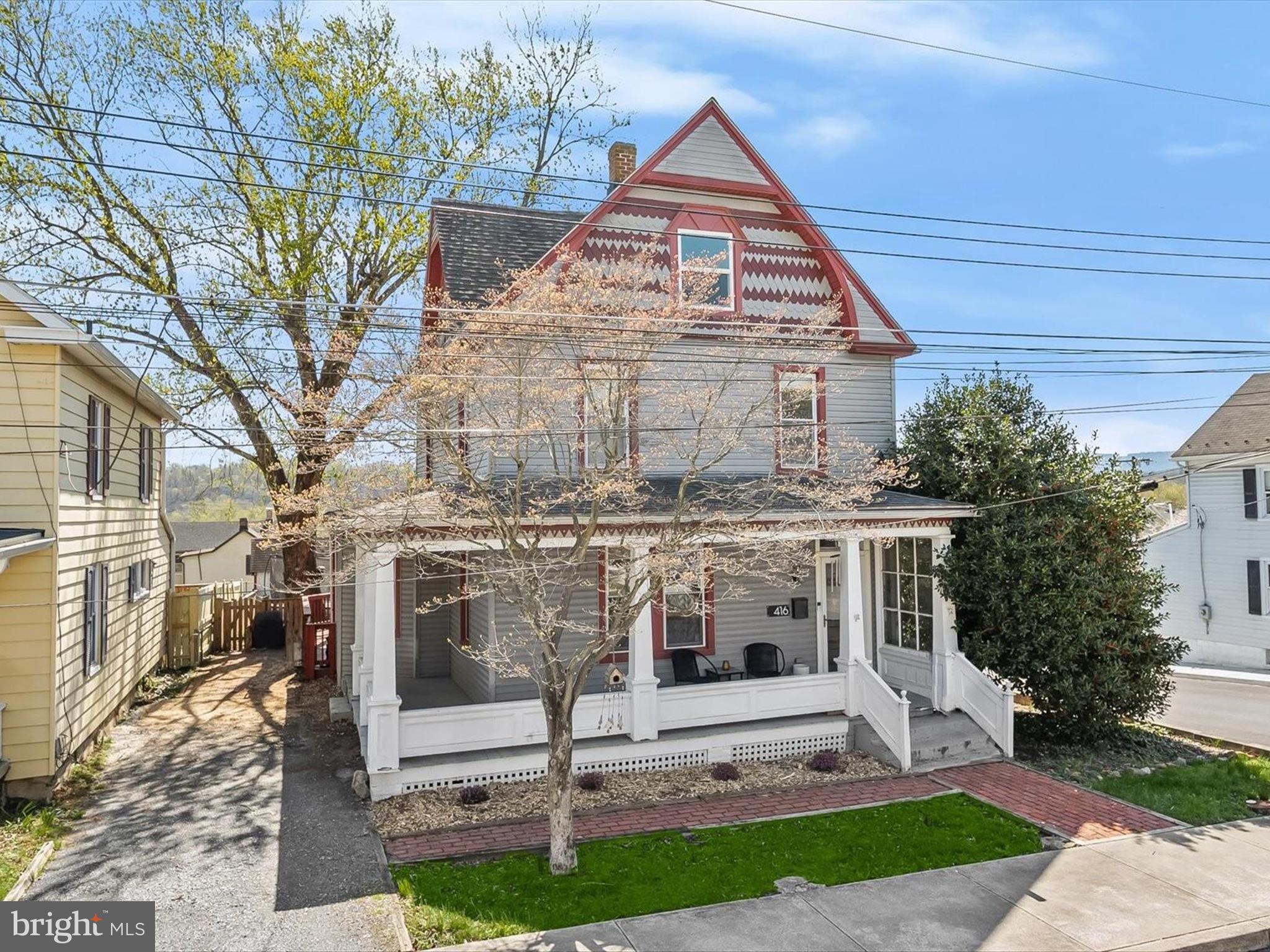 Welcome to 416 Brunswick Street, a classic 1910 beauty nestled in the heart of historic Downtown Brunswick. Thoughtfully updated while preserving its original charm, this stunning home seamlessly blends timeless elegance with modern convenience. Step inside to discover hardwood floors, French doors, and exquisite architectural details throughout. The inviting living room features classic moldings and built-in shelves, while the formal dining room boasts a charming bow window and convenient access to the main-level full bath. The beautifully updated eat-in kitchen is a chef’s delight, complete with sleek stainless steel appliances, a center island, breakfast bar, granite countertops, decorative backsplash, display cabinetry, and a pantry. Flooded with natural light, the sunroom showcases vaulted ceilings and offers direct access to the rear deck and fenced backyard, creating the perfect space for relaxation or entertaining. Upstairs, three bedrooms each with hardwood floors are accompanied by a full bath with a laundry area for added convenience. The top-level attic presents endless possibilities, ready for your final touches. Outdoor living is just as impressive, with a covered wraparound front porch, a spacious rear deck, secure storage, and a fenced backyard with breathtaking views of the mountains and passing trains. Recent updates include a new upper-level HVAC system, eight new sunroom windows, a new water heater, washer, dryer, dishwasher, refrigerator, fence, and more! Brimming with character and modern upgrades, this exceptional home offers the best of historic charm and contemporary living in a prime Brunswick location. Enjoy a vast variety of shopping, dining, and entertainment options in the towns of Frederick, Harpers Ferry, Charles Town, and Leesburg VA. Outdoor recreation awaits you at Catoctin Creek Park, Harpers Ferry National Park, C&O Canal, Gathland State Park, Big Cork Vineyards, and more! Convenient commuter routes include I-70, US-15, US-340, MD-270, US-40, and the MARC Train at Brunswick Station.
2 CATS INSIDE. PLEASE DO NOT LEAVE EXTERIOR DOORS OPEN OR LET CATS OUT.