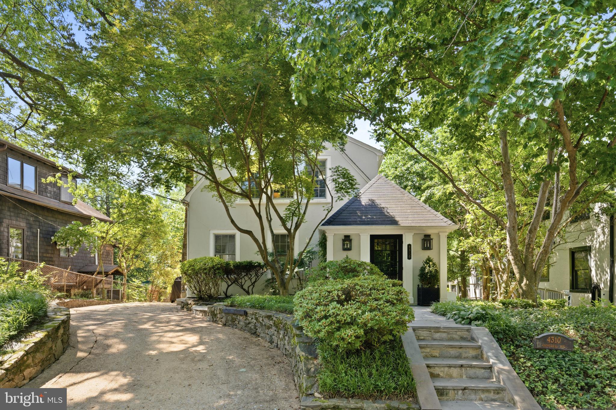 OPEN HOUSE SUNDAY 2-4PM. Presenting this exquisitely renovated Wesley Heights residence, where timeless 1920s architecture meets modern comfort and design. Set behind mature landscaping on a picturesque stretch of Cathedral Avenue, the home offers 5 bedrooms, 4 full baths, 1 half bath, and more than 3,300 square feet of thoughtfully designed living space.
Extensively renovated by Case Design Build in 2021, the home unfolds with gracious, light-filled interiors and an effortless flow for both everyday living and entertaining. The main level features a welcoming entry foyer, elegant formal living and dining rooms, and a chef's kitchen appointed with a premium suite of Miele and Sub-Zero appliances, custom cabinetry, and beautiful stone countertops. Just beyond, a dramatic sunken family room showcases soaring ceilings, custom built-ins, and a wall of windows overlooking the private rear gardens. French doors open directly to the expansive rear deck with a gas deck, creating a seamless connection between indoor and outdoor living.
Upstairs, the spacious primary suite offers a large walk-in closet and a spa-inspired bath with premium Waterworks fixtures. Three additional bedrooms and two full baths complete the upper level, while an unfinished attic provides abundant storage and future expansion potential.
The walk-out lower level offers exceptional flexibility, featuring a recreation room, kitchenette, fifth bedroom, and full bath - ideal for guests, an au pair, or extended family.
Significant capital improvements include Andersen replacement windows (2018), a new roof (2021), a multi-zone HVAC system (2017), updated plumbing and electrical systems, and extensive interior enhancements completed during the 2021 renovation.
Ideally located in sought-after Wesley Heights, 4310 Cathedral Avenue NW offers a rare combination of architectural character, thoughtful updates, and modern amenities in one of Washington's most desirable residential neighborhoods.