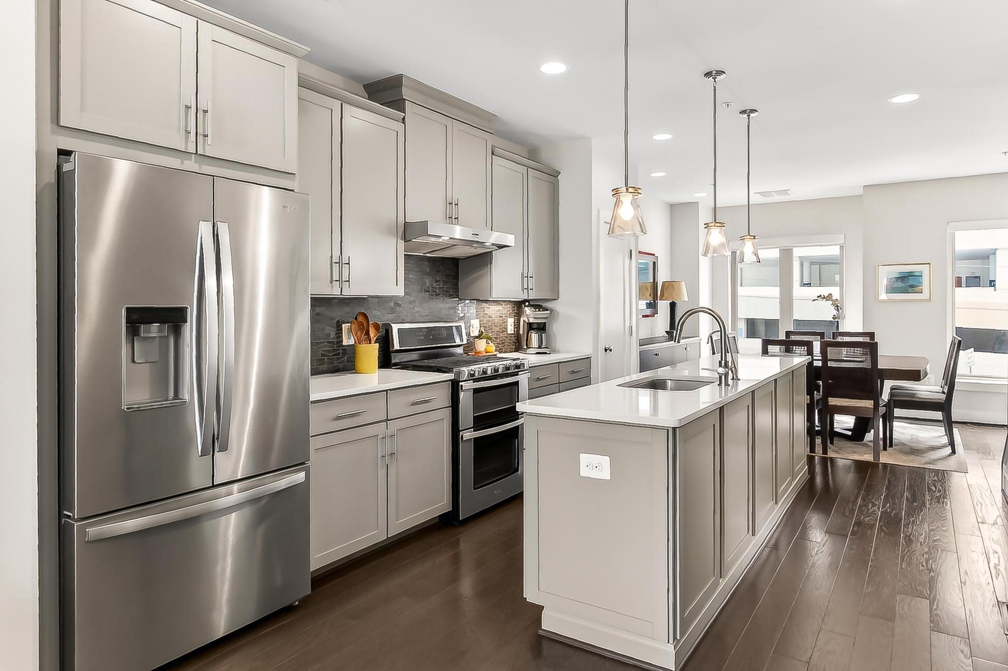 Experience elevated living in this stunning 4-level luxury townhome located in the highly sought-after Chapman Row at Twinbrook Metro community. Thoughtfully designed with high-end finishes and sophisticated details throughout, this residence offers 3 bedrooms, 3 full baths, and 1 half bath across beautifully appointed living spaces. The entry level with rich hardwood flooring welcomes you with a versatile flex space ideal for a private office, lounge, fitness area, or additional sitting room, along with a stylish powder room. Custom built-in bench seating with cubbies and hooks creates a polished and functional mudroom area just off the attached 1-car garage. The garage features built wall-to-wall shelving and additional storage space, while a private driveway provides parking for a second vehicle. ****** Hardwood flooring continues upstairs into the main living level showcasing a seamless open-concept layout designed for both everyday living and entertaining. At the heart of the home is a chef’s kitchen boasting an oversized island with pendant lighting complemented by sleek quartz countertops, designer tile backsplash, upgraded 42” cabinetry, and stainless-steel appliances including a gas range with dual ovens and vent hood—creating a true focal point. The generous dining area is ideal for both formal and casual occasions, as hardwoods flow effortlessly into the inviting living room, highlighted by a gas fireplace and custom built-in bookcases. A private balcony extends the living space outdoors. ****** The third level is dedicated to comfort and privacy, featuring a luxurious primary suite with two walk-in closets and spa-inspired bath, complete a quartz topped dual sink vanity and walk-in shower with a bench and filtered shower head. A generously sized secondary bedroom with its own en-suite bath completes this level. Custom designer barn style sliding doors enhance the laundry area, adding both style and function.  ****** The upper most level offers a spectacular loft retreat with sliding glass doors opening to a private rooftop terrace—perfect for relaxing or entertaining under the open sky. An additional large bedroom and full bath provide flexibility for guests or extended living needs. Additional upgrades include premium upgraded carpet, ceiling fans in all three bedrooms, and custom window treatments throughout, including blackout shades in each bedroom for optimal comfort. ****** Ideally situated directly across from Twinbrook Metro, this home offers exceptional walkability for true urban living. Enjoy being just moments from Pike & Rose, Tatte Bakery & Café, the post office, Congressional Plaza, GoFresh 365, Montrose Park, and a nearby community pool. Convenient access to shopping, dining, and recreation including Trader Joe’s, Target, Mom's Organic Market, Wegmans, and Woodmont Country Club further enhances the lifestyle appeal. Zoned for Farmland Elementary School, Tilden Middle School, and Walter Johnson High School. Low monthly condo fee includes water, sewer, trash, and common area maintenance. For a stylish upgraded contemporary home offering comfort and convenience in a stellar location, this is it!
