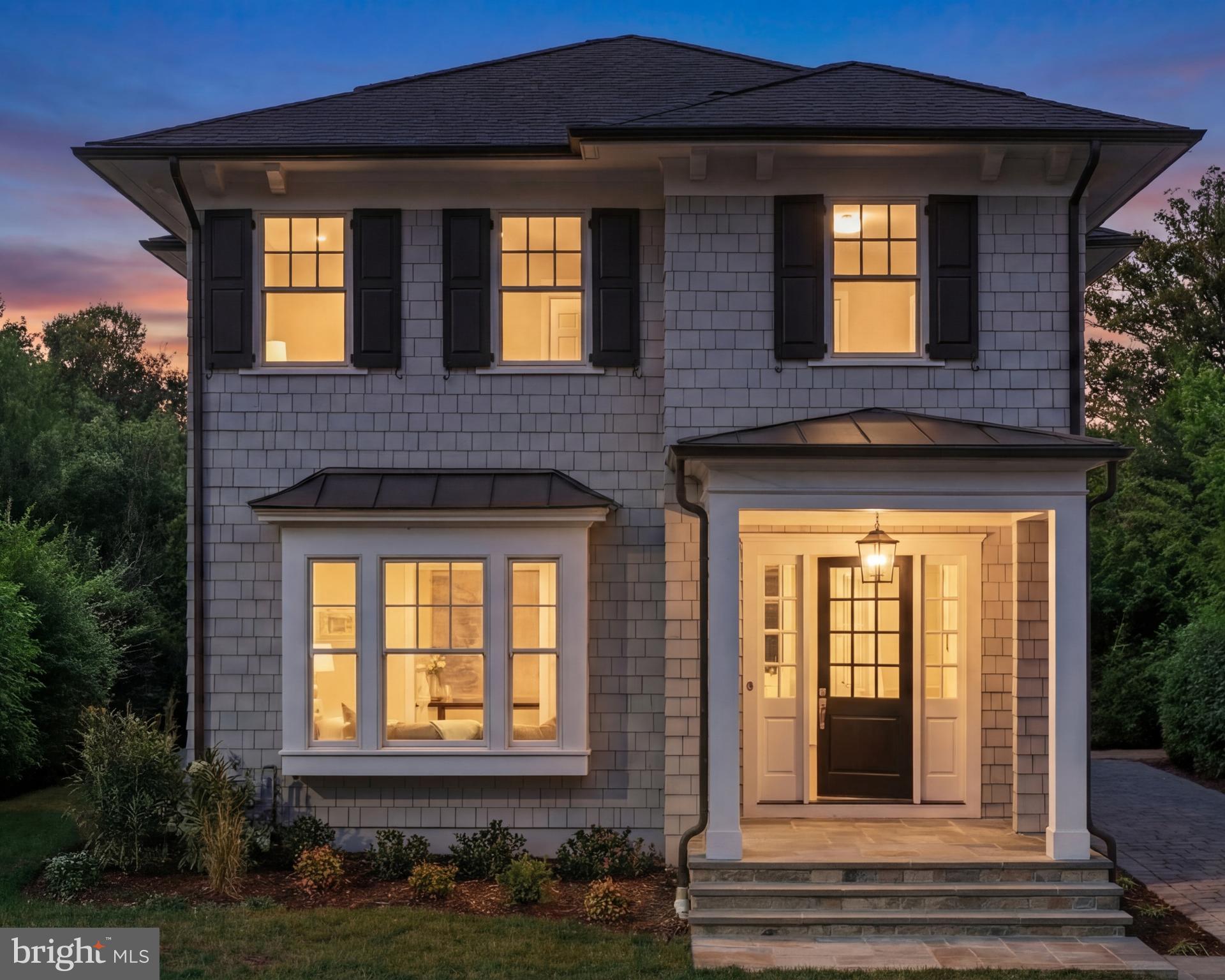 In the coveted heart of Ashton Heights, where lush tree-lined streets meet urban sophistication, 632 North Kenmore Street stands as a statement of modern artistry and refinement. Conceived by the acclaimed Ventura Group, designed by GTM Architects, and finished with interiors by Kelly Knebel Designs, the home has been thoughtfully crafted from the ground up to embody timeless elegance with a contemporary edge.
 
The exterior makes a charming first impression, with gray Hardie shingles, crisp white trim, and dark shutters evoking the quiet luxury of a Nantucket summer cottage. A deep paver driveway along the side leads discreetly to a private detached garage at the rear of the property. The entry, tucked beneath a welcoming portico, opens into a dedicated reception area, with a light-filled den situated just off to one side.
 
Inside, the ambiance is bright and ethereal. Ten-foot ceilings and eight-foot doors lend a sense of scale, while wide-plank white oak flooring and substantial Emtek hardware establish a foundation of quality. Visual Comfort and Hudson Valley light fixtures pair with WAC recessed lighting, adding layers of warmth and visual interest to the clean architectural lines.
 
At the center of the main level, the stair hall serves as a striking architectural core, where a sculptural white oak staircase is framed by soaring windows that flood the space with natural light. Opposite the staircase, the formal dining room is framed by a large wall of glass and perfectly scaled for hosting. A butler’s pantry with wine fridge connects seamlessly to the kitchen.
 
The informal living spaces span more than 30 feet across in a true open-concept layout. The family room features double sliding glass doors that open onto a screened-in porch, creating a seamless indoor-outdoor connection for year-round enjoyment. The adjacent chef’s kitchen is both stunning and functional, with custom Alpine cabinetry, a white oak island, quartz countertops, and a full suite of top-tier Sub-Zero, Wolf, and Cove appliances. A sunny breakfast area, surrounded by three walls of windows, completes the space.
 
Upstairs, the primary suite offers a tranquil retreat overlooking the rear lawn. A generous U-shaped walk-in closet is outfitted with custom built-ins, while the spa-inspired bath features radiant heated floors, a curbless shower, soaking tub, double vanity, and private water closet. Three additional bedrooms are thoughtfully laid out, one with an ensuite bath and two that share a large hall bath with double vanity. A full-size Electrolux washer and dryer are conveniently located in the upper-level laundry room.
 
The lower level echoes the main level in scale and attention to detail. A large recreation room is anchored by a wet bar with wine fridge, while a spacious fitness room and a private fifth bedroom suite offer additional flexibility.
 
The home is fully pre-wired for modern living, with ceiling-mounted surround sound, wireless signal boosters on every level, and a comprehensive video surveillance system, all backed by a 400-amp electrical panel to accommodate future smart home upgrades.
 
Out back, the level lawn is lush, fully irrigated, and perfectly proportioned, a serene and functional backdrop for outdoor entertaining or everyday play.
 
Located just steps from the Orange Line Metro and minutes from Washington, DC, 632 North Kenmore Street is a rare blend of architectural distinction, thoughtful functionality, and timeless design in one of Arlington’s most sought-after neighborhoods.