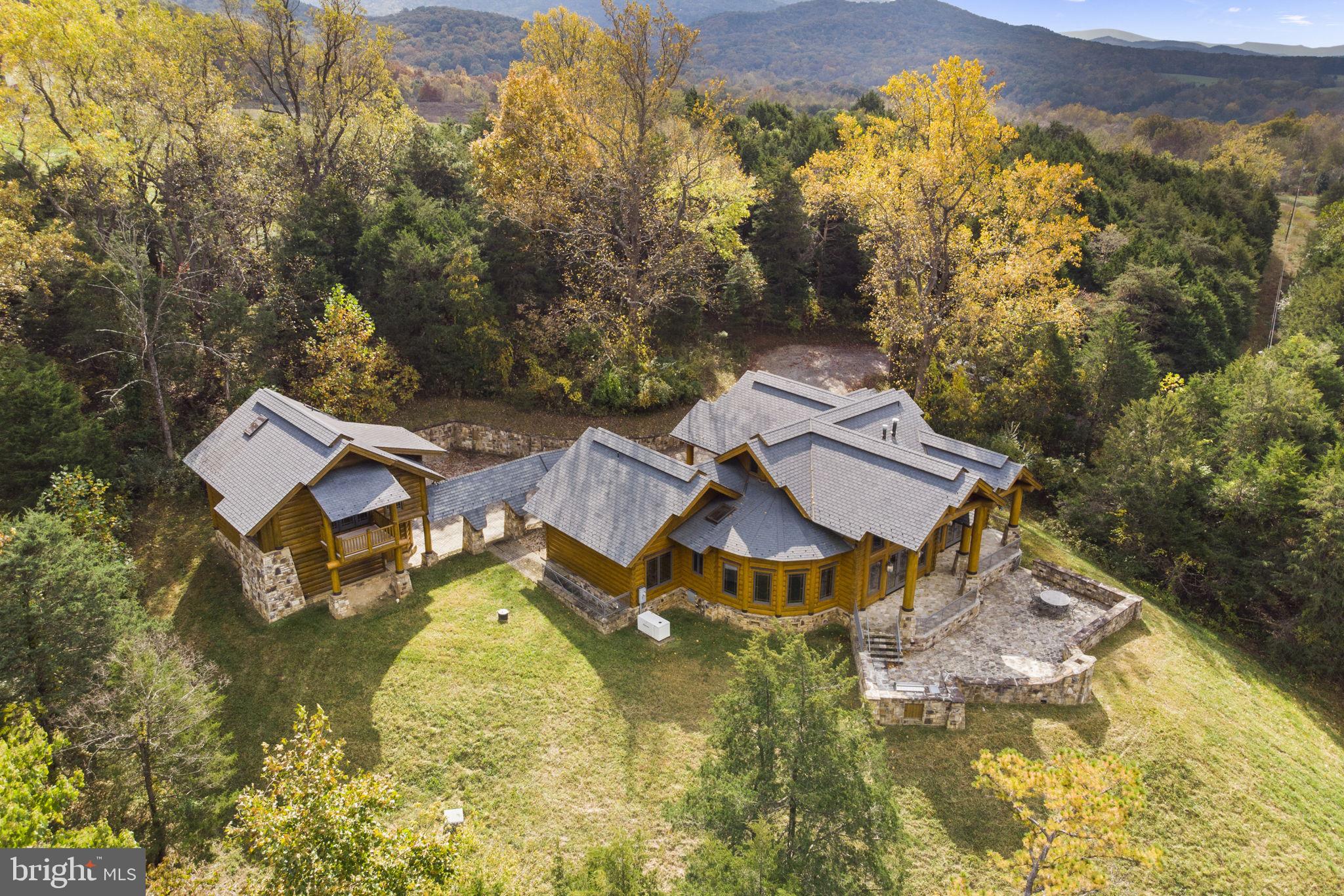 Nestled in the heart of Virginia's Shenandoah Valley stands Hamatreya, a bespoke masterpiece with unparalleled mountain vistas. This award-winning contemporary retreat, inspired by Ralph Waldo Emerson's poem "Hamatreya," redefines luxury living on almost 10 acres overlooking majestic Massanutten Mountain and the lush George Washington National Forest.

An Eco-Friendly Oasis of Modern Luxury

-As seen in three distinguished magazines, Hamatreya offers a blend of sustainable design and modern comfort. This energy-efficient haven features a main house with three distinctive bedrooms, each with en-suite bathrooms designed to emulate individual cabins, plus a carriage house complete with a studio apartment loft above a 2-car garage.

Indoor and Outdoor Elegance

-Experience breathtaking sunrises and sunsets year-round, whether through expansive windows or on the extensive stone terrace. Enjoy outdoor living at its finest with a built-in wood-burning fireplace and an outdoor kitchen.

Organic Connection to Nature

-Hamatreya's curvilinear design creates a seamless blend between indoor and outdoor spaces. A well-proportioned and defined great room, kitchen, and dining area add charm and functionality, accented by handcrafted pottery, custom lighting fixtures, and a grand stone fireplace clad in copper.

Master Craftsmanship in Every Detail

-Each bedroom with a private en-suite bathroom offers access to an open central great room and a captivating stone terrace. Custom cabinetry crafted by renowned artisans adds to the allure, as do luxurious bathrooms adorned with log and glass canopies and superior Grohe fixtures.

High Speed Internet Allows Business to Be Run from Property

-Property has Starlink Internet with speeds that effortlessly handle anything, with large throughput. specs:
 -DOWN: 117 Mbps
-UP: 8.81 Mbps
-VID: 2160p max resolution, 2014 ms, 0% buffering

Site Details

-Private, secluded property located directly off county-maintained US 340  but not visible from the highway
69 Miles from Dulles International Airport, 13 Miles from Luray Caverns Airport (KLUA), 14 miles from the Front Royal-Warren County Airport (FRR)

Build Your Dream on a Second Lot

-This offering includes a second 5-acre lot, perc-tested and primed for future development. Explore the possibilities and make Hamatreya your personal paradise today.


Green Systems/Items Include: 

Natural timber
Geothermal and radiant heat
Strategically placed solar panels
Locally sourced stone
Conservation-minded/recycled materials
Tankless -water heater
Generator
800 feet deep artesian well

Although the tax assessment lists the property as having 3, 165 square feet of above grade finished, space, based on the floor plans, the listing agent has computed approximately 3,550 above grade finished square feet for the main house and approximately 345 above grade finished square feet in the carriage house for a total of about 4,443 finished above grade square feet. Additionally, the below grade mechanical room is approximately 390 square feet, the garage is about 725 square feet counting the space for the cars and workbench as well as the closet.

The property is listed as having 3 bedrooms in the main house plus an efficiency apartment in the carriage house. The floor plans show the carriage house having a bedroom which would bring the total for the property to 4 bedrooms. Although there is a seperate space in the carriage house apartment for a bedroom, no doorway or door was put in...although that can be added.