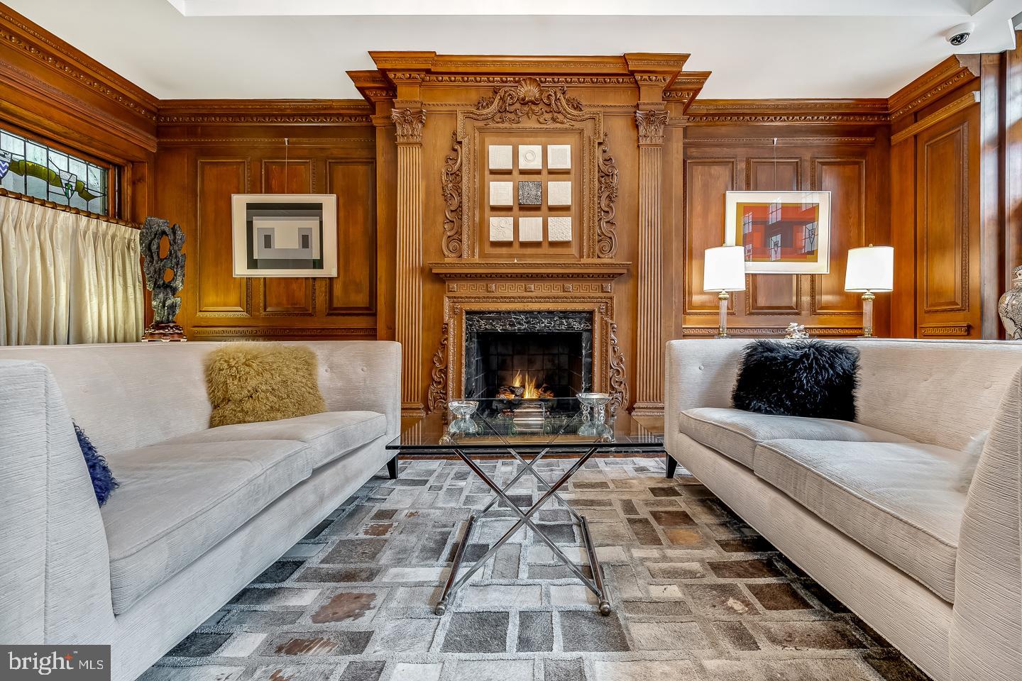 Considered by many to be the crown jewel of Delancey Place, 1827 Delancey Place is now being offered for purchase for it's next chapter in the history of Rittenhouse Square.  A stunning four bedroom, four full bathroom, two powder rooms, nearly 6000 sq ft. brick townhouse on beautiful tree lined Delancey Place, one of the most prominent blocks in Philadelphia in the Rittenhouse Square neighborhood.  Circa 1861 and retaining many original features, the home has been updated to meet today's modern needs.  There is a two car garage, extremely rare, elevator access from the basement garage access to the stunning roof deck, allowing for ease of transit between floors.  Upon entering the gracious entrance hall, with high ceilings, wainscoting, and a beautiful fireplace, one immediately knows they have arrived at a house of distinction.  From the entrance hall there is an arched hallway leading to the wood paneled drawing room with a fireplace and original stained glass-leaded windows.  There is also a stunning wet bar with a mini refrigerator/ice maker and wine refrigerator.  In addition to the elevator access there is also a powder room. Ascending the graceful staircase to the piano noble you are lead to the dining room with fireplace, original plaster crown moldings, and floor to ceiling windows that open to a Samuel Yellin wrought iron balcony. Hardwood floors through out. High ceilings, an archway hall leads past the powder room and elevator stop to the brand new kitchen.   The recently installed chefs kitchen is outfitted with custom cabinetry, Sub-zero, Wolf, and Cove appliances and Wolf appliances, and beautiful quartzite countertops.  Stunning lighting ascents illuminate the family room and fireplace. There is also a pantry with a Sub-zero wine refrigerator off of the back kitchen. Ascending the staircase to the third floor you will find two  large beautiful bedrooms each with its own unique marble bathroom.  The fourth floor has two more bedrooms with private bathrooms. The larger bedroom  with vaulted ceiling and sky light is used as the primary suite, with ample closet space with built in storage. On this floor there is also a small kitchenette with mini refrigerator and microwave, which is very convenient not only for setting up morning coffee but also extremely useful for entertaining on the roof deck.  The roof deck gives amazing views of the city skyline. There is an extraordinary tranquil waterfall, built in plant boxes with lights and watering system.  Slate flooring, natural Ipe wood in the sitting area as well as the dining area.  Gas supplied grill, and electrical outlets provide for ease of entertaining. There are many, many more amenities that have to be seen to appreciate.  1827 Delancey Place has been meticulously maintained and is in move-in condition.