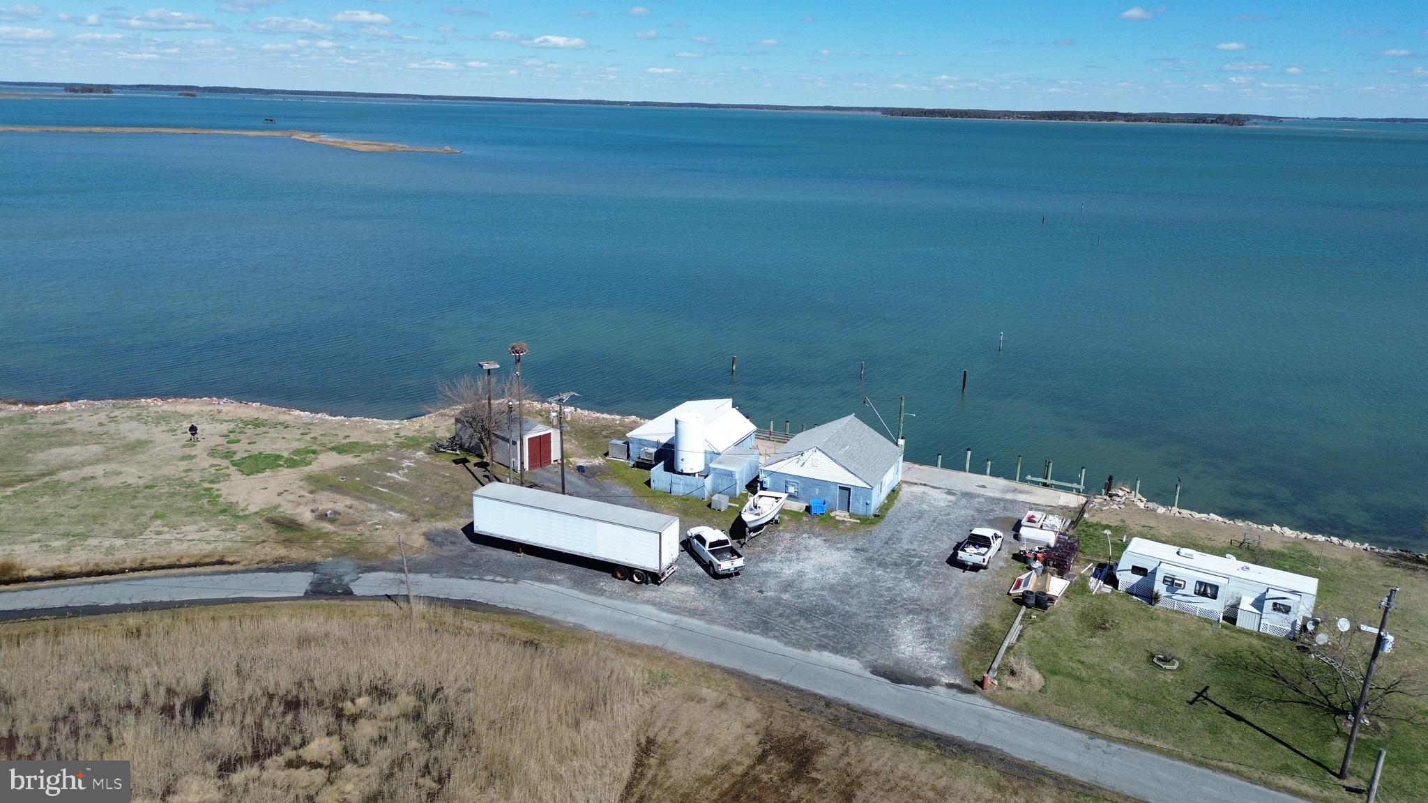 Waterfront property with bulkhead featuring two solid block buildings, shed, well and camper. Previously used as walk-in coolers for a crab factory, perfect for storage or workspace. Enjoy fishing, crabbing and boating right from your property. Ideal for watermen, hunters or anyone looking for a recreational waterfront getaway. Conveniently located, walking distance to local marina and public boat ramp. Property sold as-is.