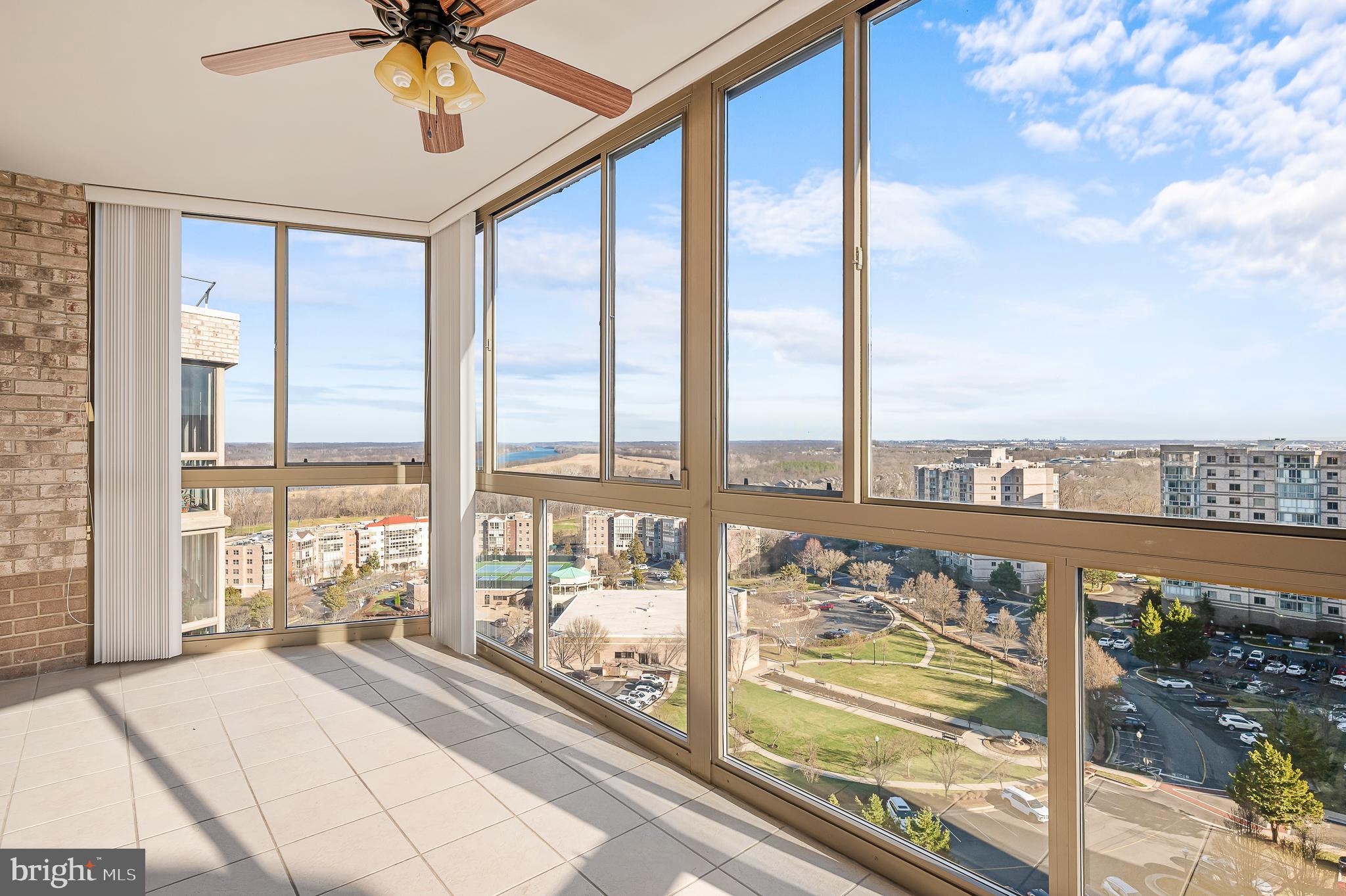 MAJOR PRICE REDUCTION! Don't miss this opportunity to enjoy the incredible views from this updated and exceptional condo in the highly sought-after 55+ community of Lansdowne Woods, offering a lifestyle of comfort, luxury, and convenience. Perched on the 11th floor, this stunning residence boasts breathtaking panoramic views of the Potomac River, community and lush greenery, creating a serene backdrop that changes beautifully with the seasons. This unit includes the ULTIMATE convenience of an INDOOR garage space (7-100), great for those rainy, windy or cold days.

Step inside and discover a bright, open floor plan designed for both relaxation and entertaining. The spacious living and dining areas are bathed in natural light, thanks to a sliding glass doors  that frame those spectacular views. The gleaming hardwood floors and neutral palette offer the perfect canvas for your personal style. The kitchen features quartz countertops, updated stainless steel appliances, ample cabinetry, and a cozy breakfast nook where you can enjoy peaceful mornings overlooking the horizon.

The primary suite is a tranquil retreat, complete with a generous walk-in closet and a beautifully updated en-suite bath. This spa-like sanctuary includes a quartz-topped vanity, a walk-in shower adorned with timeless subway tile, and striking black-and-white floor tiles for a touch of elegant modern flair. The thoughtful design doesn’t stop there—with an additional large closet, you’ll have plenty of room to keep your essentials organized and tucked away. A second bedroom and bath provide flexibility for guests, or a cozy den. The third bedroom was used as a home office and has a complete built in desk, shelving and plenty of storage.

But the crown jewel of this home might just be the enclosed sunroom—a versatile space perfect for sipping your morning coffee, curling up with a good book, or you slide open the windows and enjoy the breeze while simply taking in the sweeping vistas in all-weather comfort.  A storage unit conveys with the unit, Room #L-1 BIn 161.

Lansdowne Woods is renowned for its resort-style amenities. Residents enjoy access to a clubhouse featuring an indoor pool, fitness center, ceramics studio, library, art studio, woodworking shop, tennis courts, and a myriad of social activities. Plus, this gated community provides 24/7 security for peace of mind.

Located just minutes from shopping, dining, and medical facilities, Unit 1115 is not just a home—it’s a gateway to an extraordinary, worry-free lifestyle. Don’t miss your chance to own this slice of paradise.