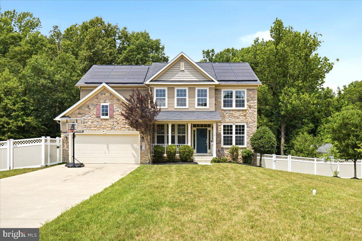 Luxury, space, and privacy come together in this stunning stone-front Colonial offering over 5,000 square feet of beautifully designed living space on a peaceful, tree-backed homesite with no HOA.
From the moment you step inside, you'll be welcomed by a grand two-story foyer, soaring ceilings, rich hardwood flooring throughout the main level and staircase, elegant crown molding, and an open, light-filled floor plan designed for both everyday living and entertaining. The main level offers the perfect balance of sophistication and functionality, featuring a formal dining room, formal living room (ideal as a sitting room or den), a dedicated home office, and a convenient powder room. At the heart of the home is the gourmet kitchen, thoughtfully appointed with an oversized center island, abundant granite countertops, custom cabinetry, stainless steel appliances, a gas stove, built-in microwave, a brand new refrigerator, recessed lighting, a pantry, and generous prep space. Just beyond, the sun-drenched morning room provides the perfect setting for casual dining while overlooking the private backyard. The kitchen flows seamlessly into the expansive family room, creating an inviting space for gatherings both large and small. Step outside onto the maintenance-free composite deck with stairs leading to the fully fenced backyard that backs to protected woods, offering exceptional privacy. A large storage shed with new siding provides plenty of additional storage. The attached two-car garage is equipped with a dedicated 220-volt EV charging outlet and breaker, adding modern convenience for electric vehicle owners. Downstairs, the expansive walkout basement is ready for your vision. Already plumbed for a future full bath and wet bar, this unfinished space offers endless possibilities for additional living space, recreation, or multigenerational living.
Upstairs, you'll find four generously sized bedrooms, including an impressive owner's retreat featuring designer board and batten accent wall treatments, a spacious sitting area, oversized windows that flood the room with natural light, a large walk-in closet, and a spa-inspired ensuite bath complete with a soaking tub, oversized separate shower, dual vanities, and a private water closet. The upper level also includes a spacious laundry room with washer and dryer (approximately three years old) that convey with the home, along with a well-appointed hall bath featuring an oversized vanity and tub/shower combination. Additional highlights include over 5,086 total square feet, 4 bedrooms, 2.5 baths, public water and sewer, a solar panel system that will be paid in full at closing for years of utility savings, and a seller-paid one-year home warranty for added peace of mind. Conveniently located with quick access to Route 5 (Branch Avenue), commuting to Washington, D.C., Northern Virginia, Joint Base Andrews, and surrounding areas is effortless while still enjoying the tranquility of a private, nature-backed setting. This exceptional Brandywine home offers the perfect blend of luxury, comfort, efficiency, and location—ready to welcome you home. CHECK OUT THE VIRTUAL TOUR