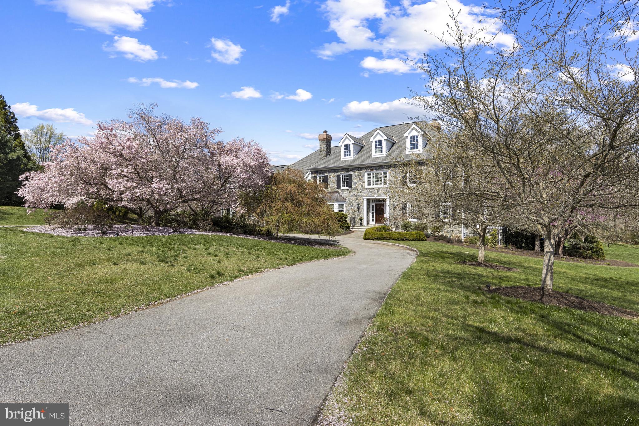 Stunning classic Greenville stone colonial home custom built in 2002 and located in the desirable community of Versailles. Enjoy the cul-de-sac location providing privacy with beautiful views out every window, just minutes from Wilmington, Philadelphia and all major corridors. Major refresh just completed. All stucco has been removed and replaced with James Hardie Siding Scope of work included many new windows and French doors. All inspections and oversite completed by Nick Hindley Environspec. This 6-bedroom, 5/2 bath home sits on a 2.26 ac lot and features classic custom millwork throughout. Enter into the stately 2-story foyer with show-stopping staircase. To the right, the beautiful formal living room has wood-burning fireplace that are flanked by built-in cabinetry. To the left of the foyer is the formal dining room with additional fireplace and bay window. The large family room features stone fireplace, built-in storage cabinets, window seat and wet-bar that leads to Butler's Pantry. The custom gourmet kitchen offers large island with seating, breakfast area and top-of-the-line appliances (3 Dacor ovens, paneled Sub-Zero fridge, etc). A private office, laundry room with dog run and informal bathroom are tucked away beyond the kitchen. A main level bedroom suite is privately located beyond the family room as well as the formal powder room. Head up either the grand main staircase or the back staircase to find a sprawling second floor landing. The luxurious owner's suite features large bedroom, his/hers walk-in closets with custom shelving system and en-suite with walk-in shower, dual vanity and water closet. An additional guest bedroom has private en-suite and walk-inn closet. Two more bedrooms share a Jack-and-Jill bath. A massive bonus room provides loads of additional finished space as well as attached unfinished attic space. The finished lower level is a perfect space for entertaining with a full bath, large game room and media room with fireplace and walk out. A lovely slate patio sits off of the family room and is a perfect space to enjoy a peaceful evening. Come see what you have been dreaming about!