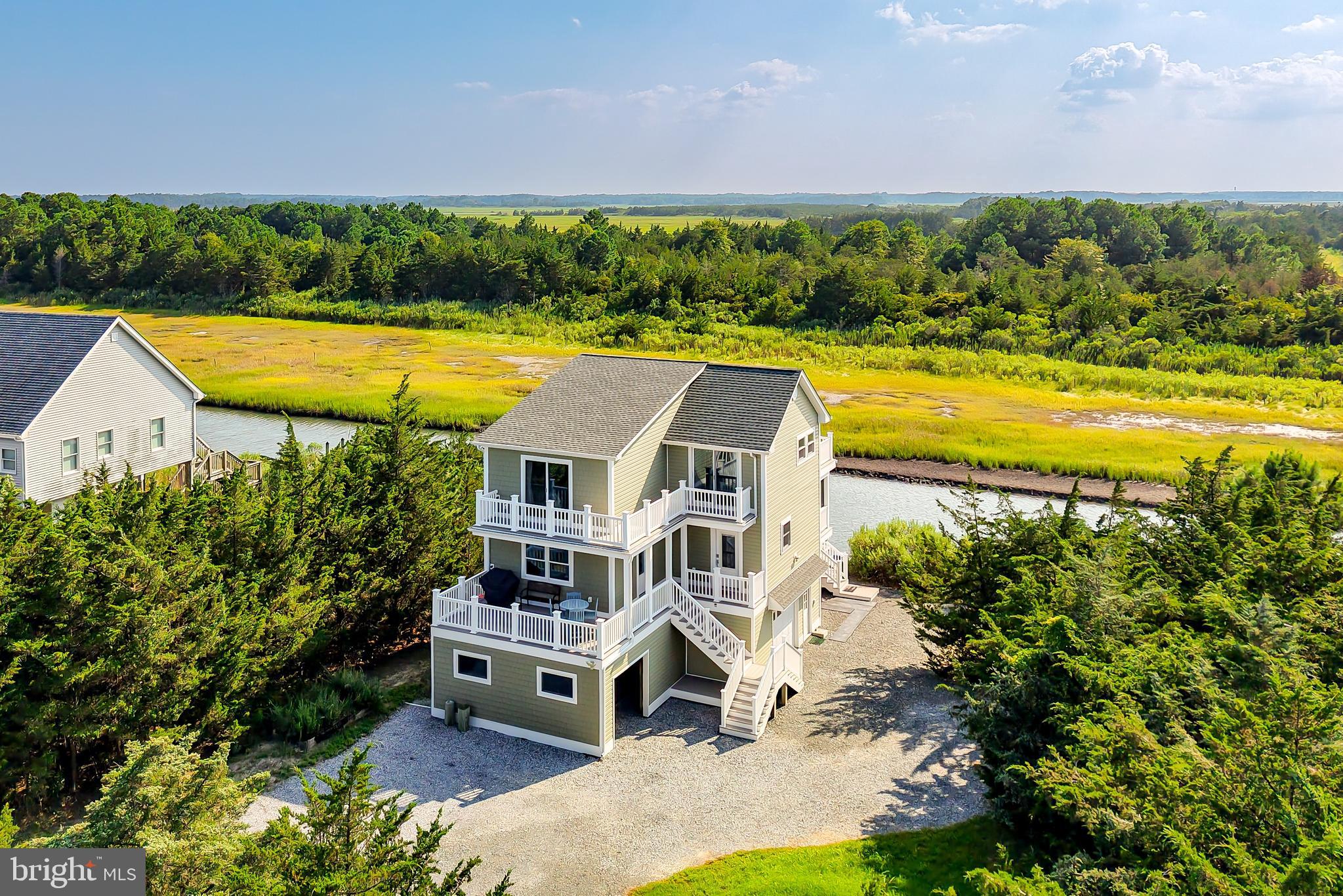 COASTAL GEM – Experience the pinnacle of coastal living in this meticulously, move-in ready, Broadkill Beach retreat. Welcome to this beautifully renovated 3-bedroom, 2.5-bath Coastal Gem offering panoramic views and exceptional rental potential. Fully updated in 2023 with new windows, doors, electrical,
plumbing, insulation, HVAC, and more, this home is 100% turnkey and move-in ready. Step
inside to a bright, open floor plan with luxury vinyl plank flooring, recessed lighting, and coastal
charm throughout. The gourmet kitchen is a showstopper, featuring quartz countertops, an
impressive 11-ft island with breakfast bar, walk-in pantry, and all-new stainless-steel appliances
including a microwave/convection combo and electric air fryer oven – perfect for entertaining or
everyday living. The spacious primary suite offers Delaware Beach and Bay views, a walk-in
closet, and a spa-like en-suite with a custom walk-in shower. Upstairs, enjoy a cozy den with
electric fireplace, wet bar with fridge, and half bath, that flows seamlessly onto an expansive waterfront deck, ideal for watching year-round sunsets. Outdoor living is unmatched: multiple decks for entertaining, a screened porch, outdoor shower, fire pit, and even a private waterside deck to launch your kayak,
canoe, crab pots, or jet skis. Bordered by Deep Hole Creek and the Prime Hook National
Wildlife Refuge, and nestled among mature trees, this home is a peaceful coastal retreat set far
back from the road for added privacy. Additional highlights include a side-entry garage, under-
home storage, and the convenience of being sold fully furnished (excluding personal property) –
perfect for a vacation home, rental investment, or year-round residence in sought-after Broadkill
Beach. Don’t miss this rare opportunity – schedule your private showing today!