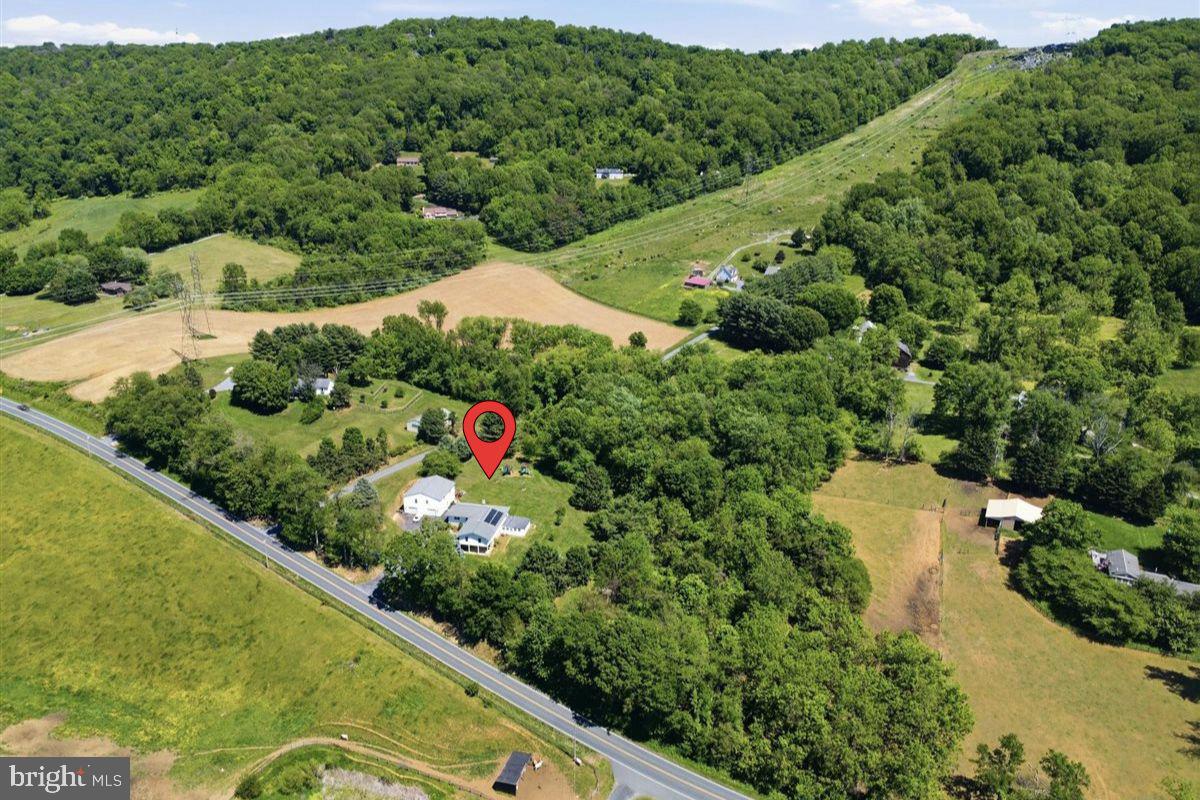 *** NEW PRICE! ***

Nestled on over 5 private acres in the scenic countryside of Jefferson, this spacious ranch-style home offers the perfect blend of privacy, flexibility, and peaceful Frederick County living. Surrounded by rolling farmland, mature trees, and open skies, the property delivers the charm of country living while still being connected to local farms, markets, restaurants and outdoor recreation.

The main level features 6 bedrooms, 2 full bathrooms, and 2,644 above-grade finished square feet with oversized bedrooms, generous living spaces, an open layout, and the warmth and character of a wood stove. Enjoy peaceful dining room views overlooking neighboring farmland where longhorns and horses can often be seen grazing across the street.

The lower-level in-law suite offers 2 bedrooms, 1 full bathroom, kitchen, and living room with its own private entrance. There is no interior access between levels, creating a completely separate living space ideal for extended family, guests or additional flexibility.

Outside, the oversized detached 4-car garage includes a finished upper-level area perfect for a studio, workshop, office, gym, or creative space. The lot itself offers a beautiful mix of partially wooded privacy and larger cleared areas ideal for horses, recreation, gardening, or enjoying the outdoors.

A rare opportunity offering space, versatility, privacy, and exceptional value all in one property.