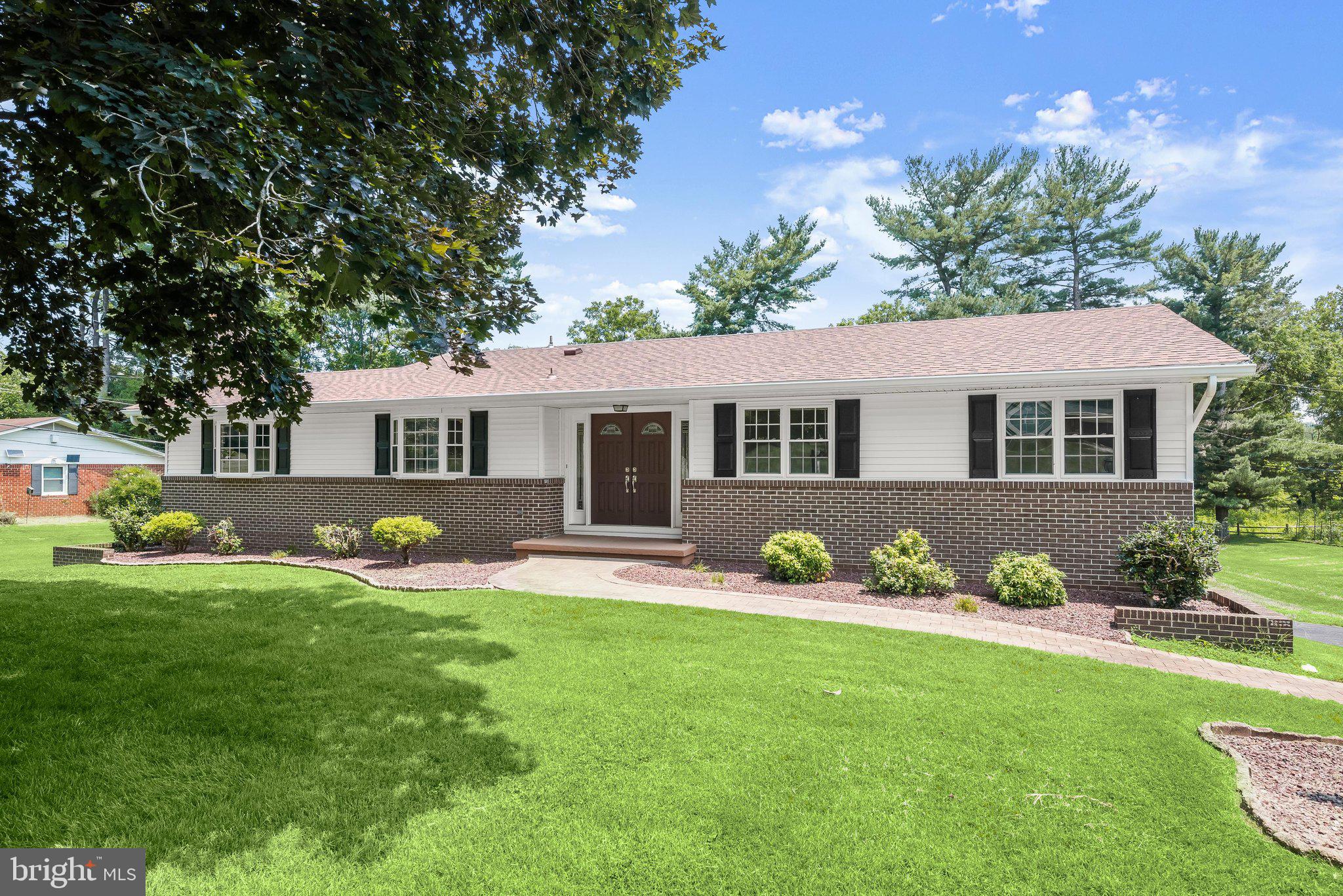 Welcome to this spacious rancher nestled on a premium 0.46-acre lot in one of Ellicott City's most sought-after communities, backing to protected non-buildable land and the scenic Little Patuxent River. Offering the perfect blend of privacy, comfort, and convenience, this well-maintained home also features an attached two-car garage, a detached one-car garage, and two storage sheds for exceptional storage and workspace.  French doors welcome you into a bright and airy floor plan enhanced by hardwood flooring, fresh interior paint, and abundant natural light. The updated kitchen features warm wood cabinetry, a charming farmhouse sink, ample counter space, and a sunny breakfast nook. Just off the kitchen, the inviting family room offers a cozy gas fireplace and convenient access to both the backyard and the finished lower level.  Hardwood flooring continues throughout all three main-level bedrooms, including the spacious primary suite with a private en-suite full bath. Two additional bedrooms and a full hall bathroom complete the main level.  The finished walkout lower level provides outstanding additional living space with a large recreation room featuring a custom wet bar, a gas stove, direct garage access, and abundant storage space.  Step outside to enjoy the peaceful backyard from the awning covered patio, all while taking in the tranquil views of the surrounding wooded landscape. Residents also enjoy access to a community gazebo and picnic area, adding to the neighborhood's appeal.  Ideally located near major commuter routes, shopping, dining, parks, and entertainment, this exceptional property offers a rare opportunity to enjoy spacious one-level living in a beautiful natural setting.