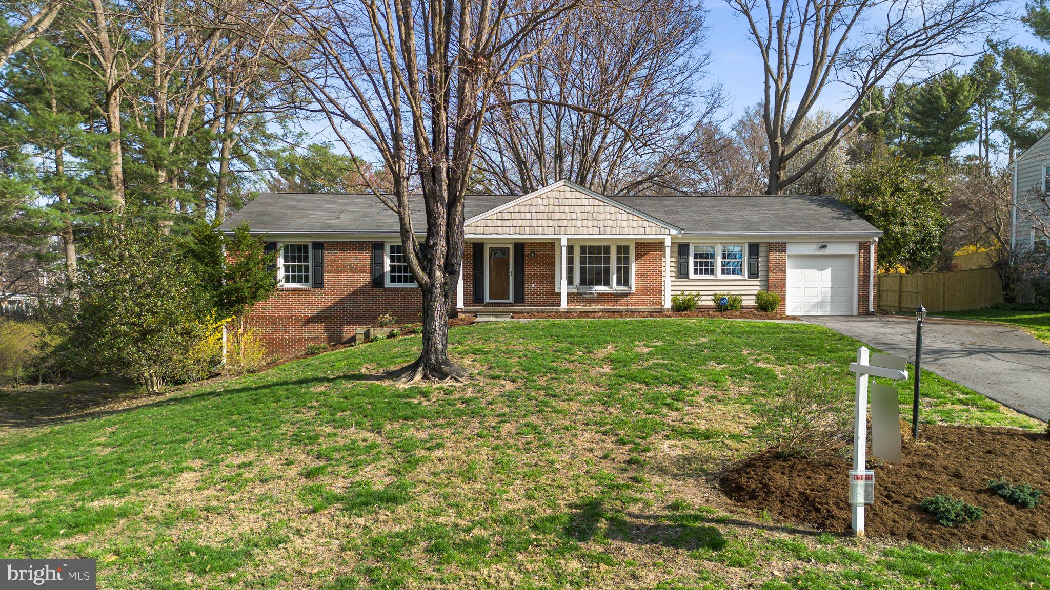 Charming and well-maintained ranch-style residence offering 4 bedrooms, 2 bathrooms, 2,469 finished square feet, and a 1-car garage in desirable Dunloggin. A welcoming front porch leads into a traditional foyer accented by vibrant slate flooring, opening to a spacious formal living room filled with natural light from a bay window. Hardwood floors flow seamlessly throughout the main level, continuing into a generously sized family room with both garage access (garage doors replaced in 2014) and exterior access for added convenience.  The thoughtfully updated eat-in kitchen, renovated in 2012, features stainless steel appliances, including double ovens, upgraded granite countertops, pendant lighting, and ample rich cabinetry with a mix of open shelving. A breakfast bar connects the kitchen to the formal dining room, creating a seamless layout ideal for everyday living and entertaining. Hardwood flooring extends into three main-level bedrooms, including the primary suite with a fully renovated en suite bath completed in 2011, while a second full bathroom was updated in 2014.  The bright, walk-out lower level offers exceptional additional living space, featuring a large recreation room with LVT flooring and built-ins, a fourth bedroom with plush carpeting, a versatile bonus room ideal for a home office, a spacious storage area, and a utility room with laundry facilities. Outdoor living is equally inviting with an open-air deck overlooking a large, open backyard, complemented by a lower patio and a detached storage shed.  Roof, HVAC, and water heater replaced in 2014.