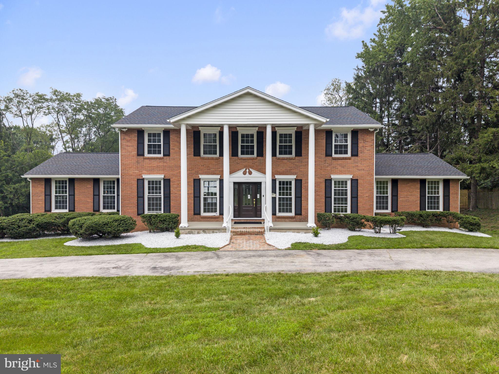 Welcome to 1215 Club House Rd., an exquisitely renovated residence where timeless Gladwyne charm meets modern luxury. Nestled on a beautifully landscaped 0.83-acre lot in one of Gladwyne's most desirable neighborhoods, this exceptional home offers 5 bedrooms, 4 full bathrooms, and 1 half bath in the award-winning Lower Merion School District. A circular driveway leads to the dignified front entrance, highlighted by elegant two-story columns that create a grand first impression. Inside, a bright, open floor plan seamlessly connects the main living spaces, providing the perfect setting for both everyday living and effortless entertaining. Every detail of this home has been meticulously updated, featuring exceptional craftsmanship and today's most desirable finishes. Major improvements include a new roof, new hardwood flooring, a redesigned staircase, beautifully renovated bathrooms, a fully updated kitchen with custom cabinetry, and much more. At the heart of the home is the stunning gourmet kitchen, featuring quartz countertops, custom cabinetry, premium Café stainless steel appliances, a spacious breakfast area, and a convenient butler's pantry. The kitchen flows effortlessly into the sun-filled family room, where skylights and sliding glass doors overlook the tranquil backyard and provide access to the deck and the covered rear porch with a fireplace. The spacious formal living room is filled with natural light and anchored by a striking double-sided gas fireplace, creating a warm and inviting atmosphere. The fireplace extends to the covered rear porch, allowing you to enjoy cozy evenings and seamless indoor-outdoor living year-round. The main-level primary suite offers the convenience of first-floor living and features a spacious walk-in closet with a laundry area and a luxurious ensuite bath. Upstairs, a second primary suite includes another oversized walk-in closet and a private ensuite bath, while two additional generously sized bedrooms share a beautifully appointed full bathroom. The finished walkout lower level provides exceptional additional living space, featuring a spacious recreation room with a gas fireplace and direct access to the ground-level backyard patio. This level also includes a private guest suite complete with a walk-in closet, ensuite bath, and its own laundry area, making it ideal for overnight guests, extended family, or an au pair. An additional finished space offers endless flexibility for a home gym, media room, playroom, or home office. Additional highlights include an oversized two-car garage, a whole-house generator for added peace of mind, professionally landscaped grounds, recessed lighting, rich hardwood flooring, and designer ceramic tile bathrooms. Perfectly situated in a quiet, safe, and close-knit community surrounded by parks, nature preserves, and miles of scenic hiking trails, this home is just minutes from Center City Philadelphia via I-76, I-476, and multiple regional rail lines. Philadelphia Country Club is only minutes away, while the charming shops, restaurants, and cafés of Gladwyne, Bryn Mawr, and Conshohocken are all within easy reach. Offering the very best of Main Line living, this exceptional home is truly move-in ready. Simply unpack and begin enjoying the Gladwyne lifestyle at its finest. For added confidence, the home also includes a two-year Select Home Warranty, providing valuable protection and peace of mind for the new owner.