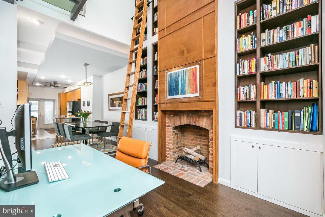 Welcome to one of Federal Hill's most architecturally unique and beautifully designed homes. As if that weren't enough, you will love the parking for 2-3 cars! 1226 S. Charles has a sophisticated design and fully open concept desired by today's most discriminating buyers. The home is like no other, boasting a variety of unique and wonderful features. Meticulously designed and gut-renovated, you'll appreciate and be amazed by the unique architectural elements. Highlights include CitiQuiet soundproof windows which supplement double hung windows and provide both sound attenuation and energy efficiency. Additional beautifully designed elements include a two-story library with a UV-protected skylight which brings natural light into the home. The striking library is complemented by a custom 13' rolling ladder and 7 built-in bookcases and custom cabinetry. Elegant wood paneling graces both the living room and library bringing warmth and sophistication to the home. An exceptional steel bridge with glass flooring and cable rail runs across the second level and serves as a centerpiece of the home. The living room, dining room, and kitchen are enhanced with dropped ceilings which include tray lighting creating a lovely ambiance. There are so many more features including a spacious rooftop deck where you'll enjoy city and stadium views, 2 wood-burning fireplaces, gorgeous contemporary full baths, walk-in closets,fabulous soapstone countertops, bamboo floors and a neat garage door providing for secure parking and outdoor versatility! Low property taxes due to an existing CHAP credit provides value. You must see this home to fully appreciate its beauty and all that it offers -- make a private appointment today!
