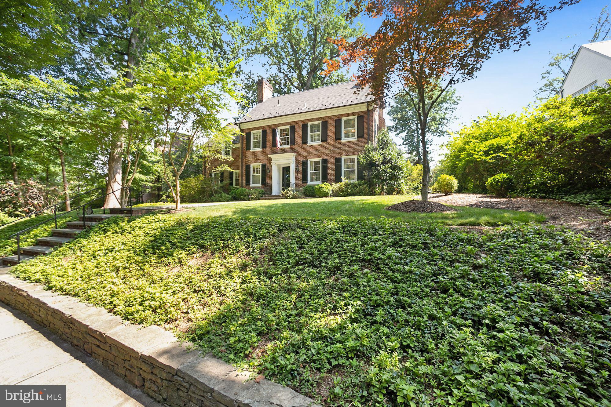 Situated on one of Washington's most coveted streets, this elegant brick Colonial exudes charm and grace. A truly exceptional property, it overlooks parkland and trails with views that delight year round. Over 5,000 square feet of updated interior space featuring hardwood floors, beautiful moldings and abundant natural light gives way to a large yard with a gorgeous stone patio, lush plantings and open green space. This home is a private urban oasis. With five bedrooms, four full and two half baths, an eat-in kitchen with a connecting family room, formal living and dining rooms, stunning sun room, multiple office spaces, lower level family room, fitness room, and a two car garage spread out over four finished floors this home truly has it all.