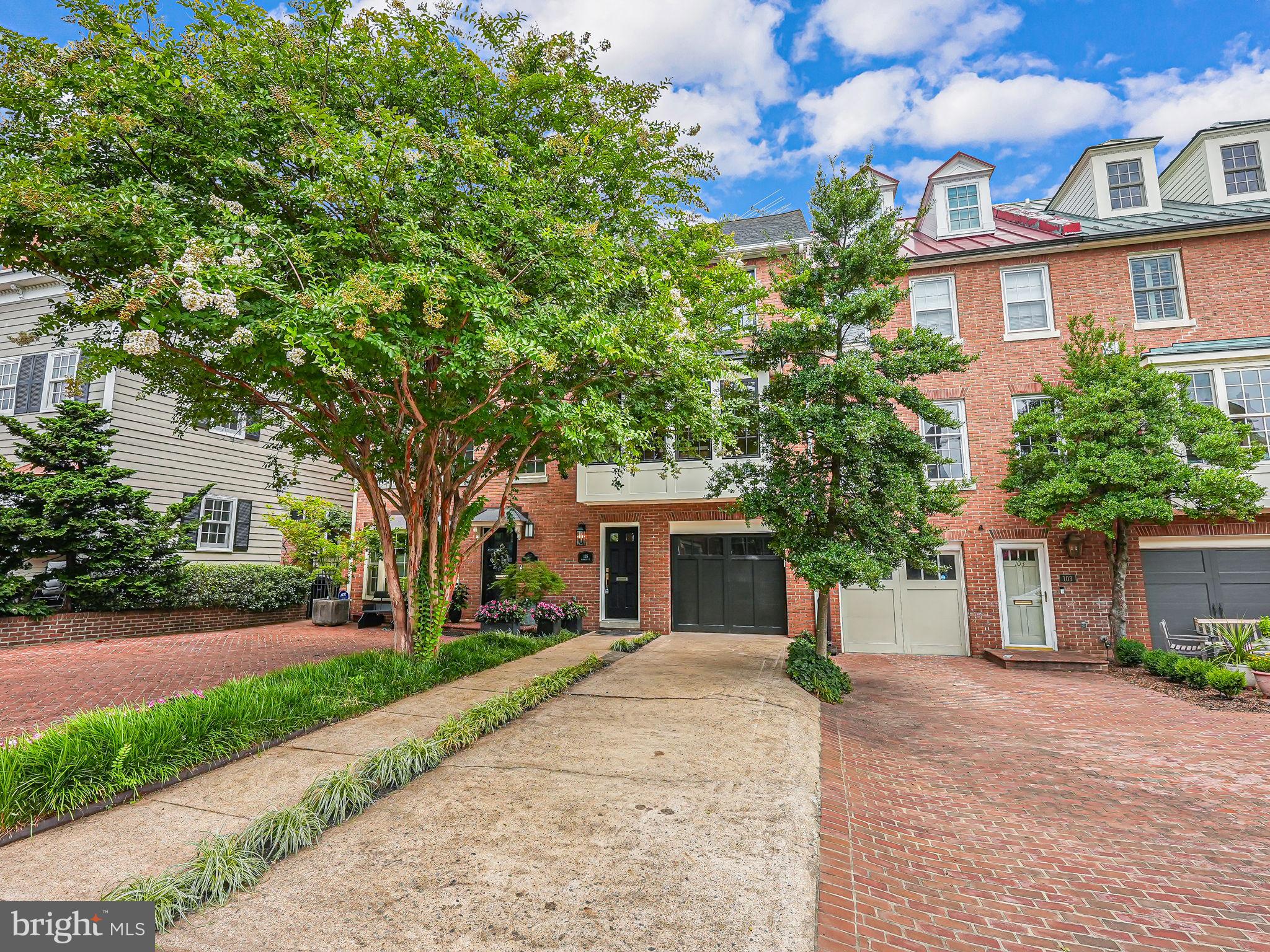 Nestled in the prestigious Pommander's Walk and just steps away from the serene Potomac River waterfront, this spectacular brick townhome epitomizes luxury and elegance. Boasting meticulously updated living space spread across four magnificent levels, this residence features 3 spacious bedrooms and 4.5 pristine baths. The grandeur of this home is immediately evident with its soaring high ceilings, exquisite hardwood floors, and sophisticated light fixtures that create a warm and inviting ambiance throughout. As you step into the gracious foyer, you are welcomed by a charming hall tree storage bench complete with hooks and cubbies, setting the tone for the refined aesthetic found throughout the home. The family room, adorned with a wood-burning fireplace and a stunning wall of built-in shelves, offers a perfect retreat for relaxation. This level also includes a convenient laundry area with a stackable washer and dryer and two elegant glass French doors leading to a private stone-paved rear patio, ideal for outdoor gatherings. Ascending to the next level, you will be captivated by the gourmet kitchen's large bay windows, allowing natural light to flood the space. This chef's dream kitchen features a grand island with leg columns, custom pendant lighting, and two-tone cabinets with chic brass hardware. The sleek matte white appliances add a contemporary touch, making this kitchen as functional as it is beautiful. Adjacent to the kitchen is an inviting dining area, which seamlessly flows into a living area complete with custom built-in shelves surrounding a wood-burning fireplace with a marble frame and a mantle. French doors from the living area open onto a spacious trek deck, perfect for alfresco dining and entertaining. The next level is dedicated to the luxurious owner's suite, featuring a generous walk-in closet and two additional closets. The lavish en-suite bath boasts a double vanity and a large shower with glass doors, offering a spa-like retreat. A second bedroom on this floor also provides ample storage with two closets, and a full bath with a vanity and tub/shower is conveniently located in the hallway. The topmost level of this splendid home is a versatile fully finished area illuminated by two skylights. This space, complete with a full bath, closet, and wet bar with a mini-fridge, can serve as a third bedroom, a home office, or a flexible living area to suit your needs. Beyond the exquisite interiors, Pommander's Walk offers an unbeatable location in Old Town Alexandria. Residents enjoy easy access to the vibrant boutiques, dining, and nightlife along King Street. Daily conveniences such as coffee shops, the renowned Balducci's food market, and various eateries are just a short stroll away. With downtown DC and Reagan National Airport within a quick drive, and the King Street Metro Station nearby, this home's location is truly unparalleled. Experience the epitome of sophisticated urban living in this magnificent Pommander's Walk townhome, where timeless elegance meets modern convenience.