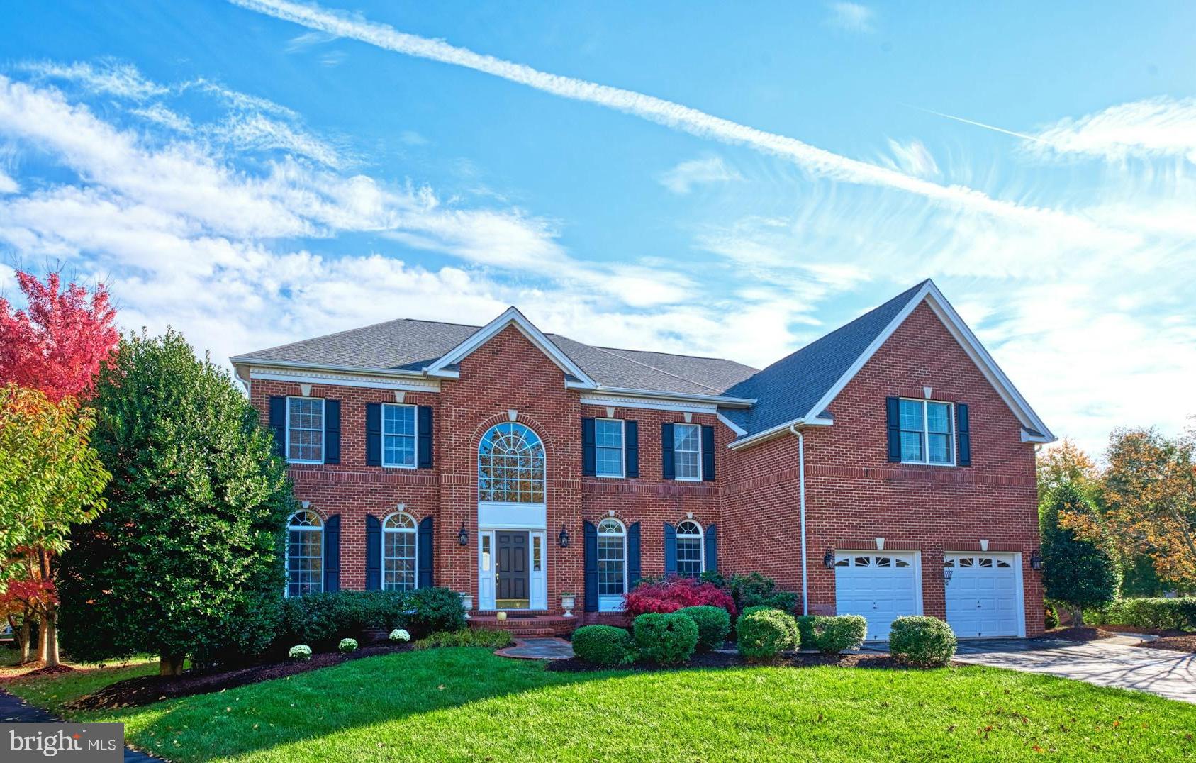 Welcome home to this stunning brick front Carlton expanded model on a .34 acre cul-de-sac lot in the prestigious Belmont Country Club community. This home features 5 bedrooms, 5.5 baths, nearly 7000 square feet of living space, upgraded wide plank hardwood flooring, custom paint & upgrades throughout. The grand two story foyer with upgraded chandelier greets you as you enter the home. The large living room / second home office opens to the formal dining room with bay window. The expansive kitchen features upgraded cabinetry, center island & sitting area. The large breakfast room features walls of windows, skylights & access to the rear entertaining space. Grand two-story family room with wall of windows, floor to ceiling stone gas fireplace & dual ceiling fans. Sought after main level guest bedroom / playroom with walk-in closet & private full bath. The main level also features a private home office, mudroom with sink & built-in cabinetry, powder room & rear staircase with new carpet. The upper level primary suite with coffered ceiling, sitting room, large walk-in closet & private bathroom with separate shower & soaking tub. The upper level features three additional spacious bedrooms with ample closet space & two full baths. The open concept finished walk-up lower level is ideal for entertaining with a large recreation room, wet bar, game / pool table area, exercise / gym area, movie / media area, 5th full bath & storage! Private patio overlooks the rear & side yards! Roof replaced in 2021, updates to HVAC systems & more. The monthly HOA Fee includes lawn mowing, high speed internet, cable TV, trash removal, community swimming pool, playground & more. This home is conveniently located nearly local dining, shopping, entertainment & commuter routes.