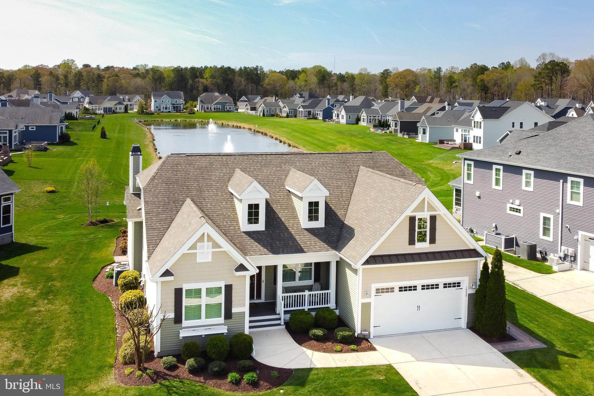 EXPERIENCE UNPARALLELED LUXURY and amenities galore that are sure to elevate your life from this stunning pond-front home in Coastal Club! Boasting hardwood flooring and high-end finishes throughout the main living area, including the gourmet kitchen with sleek stainless steel appliances & natural gas cooking, the inviting living room with floor-to-ceiling stone fireplace, as well as the dining room with loads of natural light, built-in cabinetry and sparkling pond views. The private primary suite offers a serene retreat, perfectly separated from the two additional first-level bedrooms, plus a cozy study, complete with built-ins for easy storage. The highlights continue with the basement, which is truly entertainment central with a spacious rec room with a built-in wet bar, and a dedicated theater room all perfect for hosting memorable gatherings. Outside, reap the benefits of energy savings from the solar panels installed on the roof, and enjoy the three-season screened porch & the paver patio with built-in fireplace all overlooking your lush green lawn with private well irrigation & the serene community pond. Regardless of the season, this home provides ample accommodation for entertaining and unwinding. 
Nestled just a short drive from the beautiful Lewes and Rehoboth Beaches, you'll enjoy the perfect blend of serene living and vibrant coastal culture. Indulge in the community's infinity pool with a swim-up bar, perfect for leisurely afternoons. Stay active year-round with the community’s nature walking trail, indoor pool, tennis courts, fitness room & clubhouse. Don't miss the opportunity to make this extraordinary home your own. Experience the ultimate in luxury living at Coastal Club today!