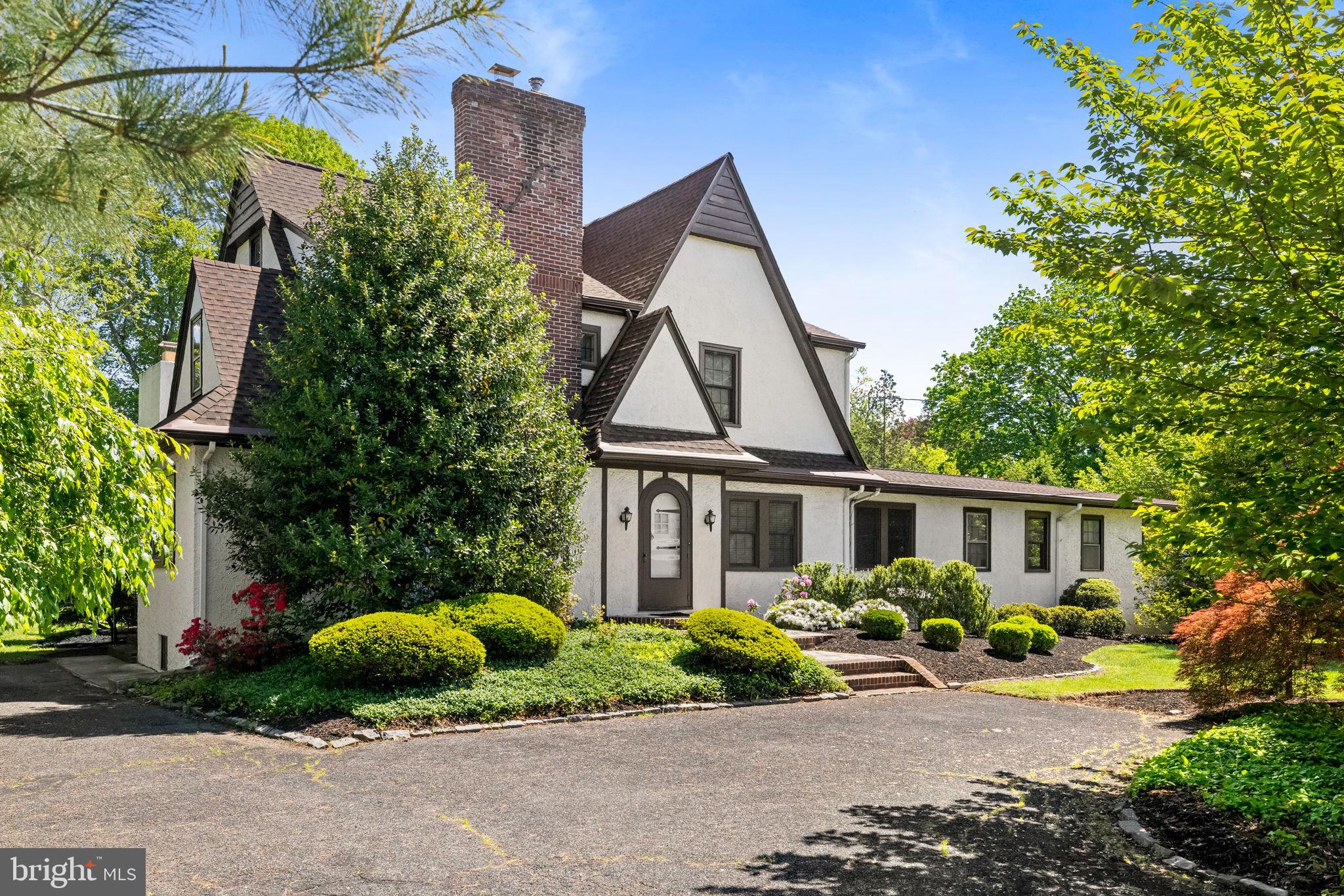 Luxury Live Auction! Bidding to start from $850,000.00! 
Welcome to this stately Tudor situated on a double lot, this private parcel gives the sense of space in the country while being in close proximity to downtown Yardley. Hop on the train to Philadelphia or experience the many wonderful opportunities for shopping and dining at your fingertips. The home is graceful and blends an earlier era with modern spaces such as the great room addition which was thoughtfully completed by the current owner.  The 1st floor office is wonderfully private featuring its own entrance and incredible versatility. This space can have a multitude of uses including a private 1st floor bedroom suite for in-laws, an au-pair, art studio, fun zone and more! Just bring your vision for this roughly 1500 sqft space. The upper level of the home consists of 4 bedrooms and 2 full bathrooms including the primary suite. Additional amenities include a central vac system, generator for the whole house including office, 3 zone heating/cooling, Newer roof, laundry chute, dual staircases and partially finished basement. Detached 2 car garage and plenty of parking and space to play. Enjoy the many benefits of this exceptional property in a fantastic location in Yardley with easy access for commuting to NYC, Princeton and Philadelphia.