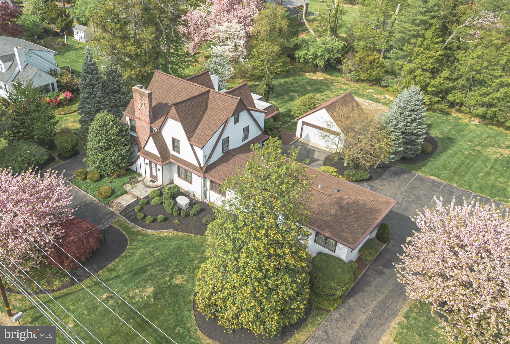 Welcome to this stately Tudor with exceptional live and work from home opportunities. Situated on a double lot, this private parcel gives the sense of space in the country while being in close proximity to downtown Yardley for the train to Philadelphia and shopping and dining. The home is graceful and blends an earlier era with modern spaces such as the great room addition with vaulted ceiling which was thoughtfully completed by the current owner.  A separate office that includes a reception area, several offices, half bath and a private, separate entry allowing clients to visit without disturbing the primary living space. Great visibility on Yardley Morrisville Road is ideal for marketing a small business with fantastic parking in the back. The separate home office can also be converted to a private 1st floor bedroom suite for in-laws, an au-pair or more! 4 bedrooms including the primary suite are on the upper level. Additional amenities include a central vac system, generator for whole house including office, 3 zone heating/cooling, Newer roof, laundry chute and dual staircases. Enjoy the many benefits of this exceptional property in a wonderful location in Yardley.