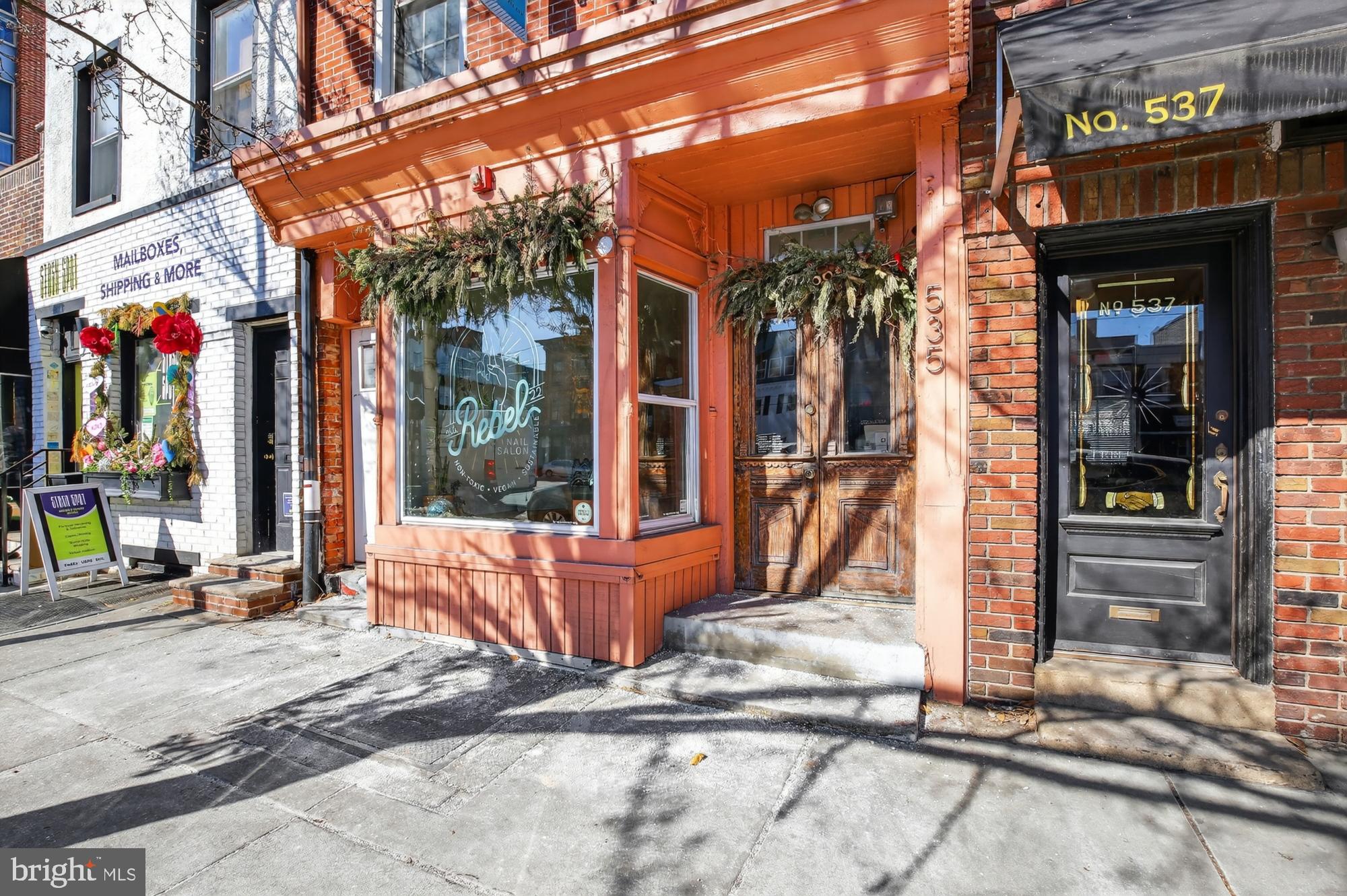 [Back on the market after buyer could not secure loan approval.] EXCEPTIONAL FISHTOWN LOCATION for a mixed-use property, well-positioned along Girard Avenue where steady foot traffic meets everyday neighborhood living. This well-maintained duplex offers two income-producing units—one commercial and one residential—creating a balanced investment with immediate cash flow and long-term appeal.

UNIT #1 – Commercial (Street Level)
The street-level commercial space enjoys strong visibility along Girard Ave and is currently leased to a neighborhood-favorite nail salon. Inside, the space blends character with functionality, featuring hardwood floors, an exposed brick wall, and large front windows that bring in natural light and showcase the business to passing foot traffic. The layout includes a raised front entry, additional rooms toward the rear, a generously sized bathroom with storage shelving, and direct access to a small back patio. An unfinished basement provides substantial storage space, adding flexibility for a variety of business uses.

UNIT #2 – Residential (Upper Levels)
The residential unit is a bright, bi-level one-bedroom apartment with its own private entrance and a loft-inspired design. Exposed brick, hardwood floors, and high ceilings give the space warmth and architectural interest, while oversized windows fill the home with natural light. The main level features a spacious living area and an eat-in kitchen with ample cabinetry, a gas range, dishwasher, and in-unit laundry. Upstairs, the bedroom offers soaring ceilings, a large walk-in closet, and an airy, open feel that sets it apart from a typical one-bedroom layout. A generously-sized bathroom with modern finishes completes the space.

PROPERTY HIGHLIGHTS: Fully-occupied mixed-use duplex with consistent rental income. Prime Fishtown location with strong pedestrian activity and residential demand. Separate entrances for commercial and residential units. Character-rich residential apartment that attracts long-term tenants. Street-facing commercial space suited for a variety of neighborhood-serving businesses.

Don't miss this compelling opportunity for investors seeking reliable income in a vibrant, walkable corridor with enduring appeal. Schedule your tour today!
