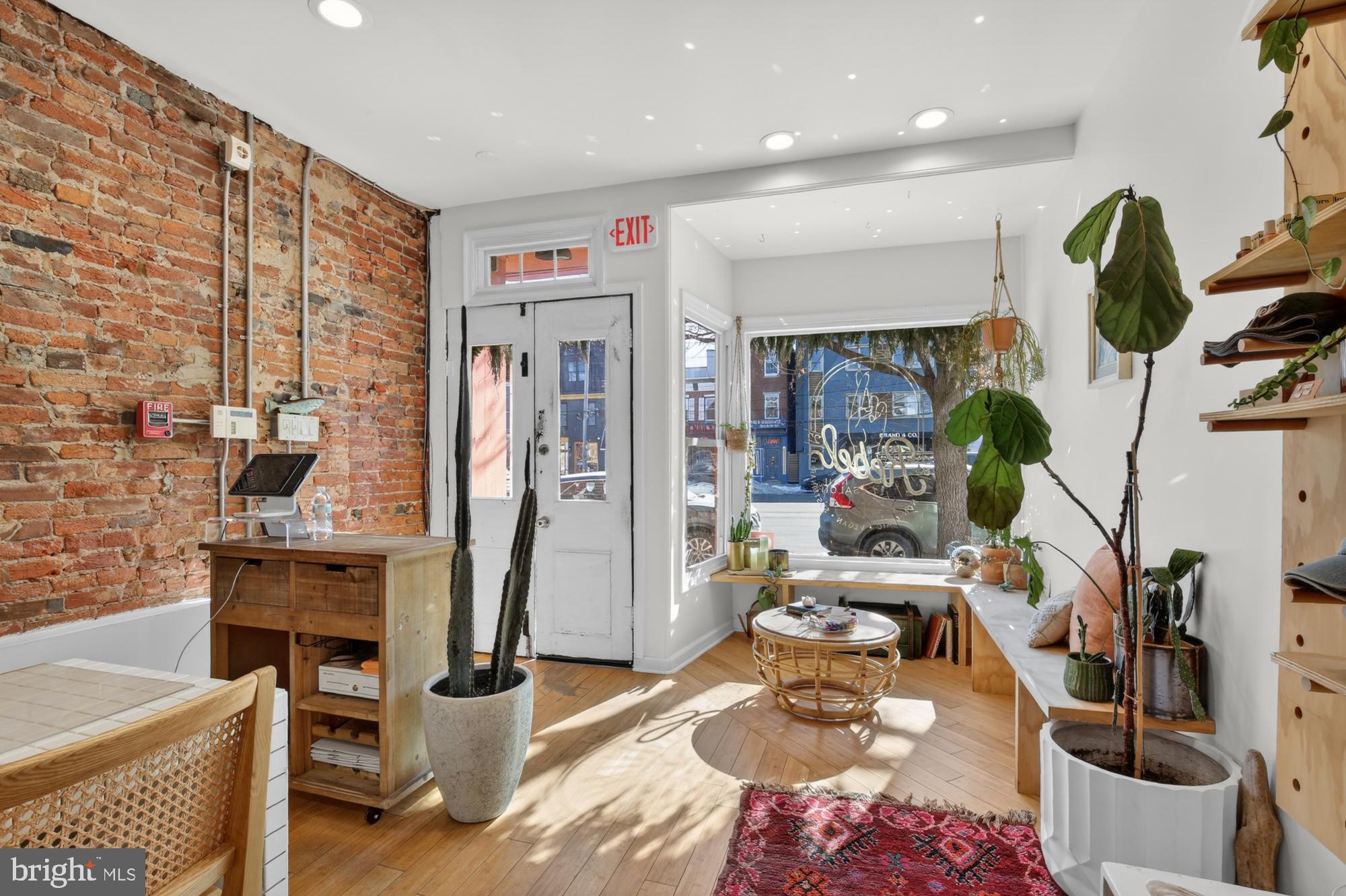 [Back on the market after buyer could not secure loan approval.] EXCEPTIONAL FISHTOWN LOCATION for a mixed-use property, well-positioned along Girard Avenue where steady foot traffic meets everyday neighborhood living. This well-maintained duplex offers two income-producing units—one commercial and one residential—creating a balanced investment with immediate cash flow and long-term appeal.

UNIT #1 – Commercial (Street Level)
The street-level commercial space enjoys strong visibility along Girard Ave and is currently leased to a neighborhood-favorite nail salon. Inside, the space blends character with functionality, featuring hardwood floors, an exposed brick wall, and large front windows that bring in natural light and showcase the business to passing foot traffic. The layout includes a raised front entry, additional rooms toward the rear, a generously sized bathroom with storage shelving, and direct access to a small back patio. An unfinished basement provides substantial storage space, adding flexibility for a variety of business uses.

UNIT #2 – Residential (Upper Levels)
The residential unit is a bright, bi-level one-bedroom apartment with its own private entrance and a loft-inspired design. Exposed brick, hardwood floors, and high ceilings give the space warmth and architectural interest, while oversized windows fill the home with natural light. The main level features a spacious living area and an eat-in kitchen with ample cabinetry, a gas range, dishwasher, and in-unit laundry. Upstairs, the bedroom offers soaring ceilings, a large walk-in closet, and an airy, open feel that sets it apart from a typical one-bedroom layout. A generously-sized bathroom with modern finishes completes the space.

PROPERTY HIGHLIGHTS: Fully-occupied mixed-use duplex with consistent rental income. Prime Fishtown location with strong pedestrian activity and residential demand. Separate entrances for commercial and residential units. Character-rich residential apartment that attracts long-term tenants. Street-facing commercial space suited for a variety of neighborhood-serving businesses.

Don't miss this compelling opportunity for investors seeking reliable income in a vibrant, walkable corridor with enduring appeal. Schedule your tour today!