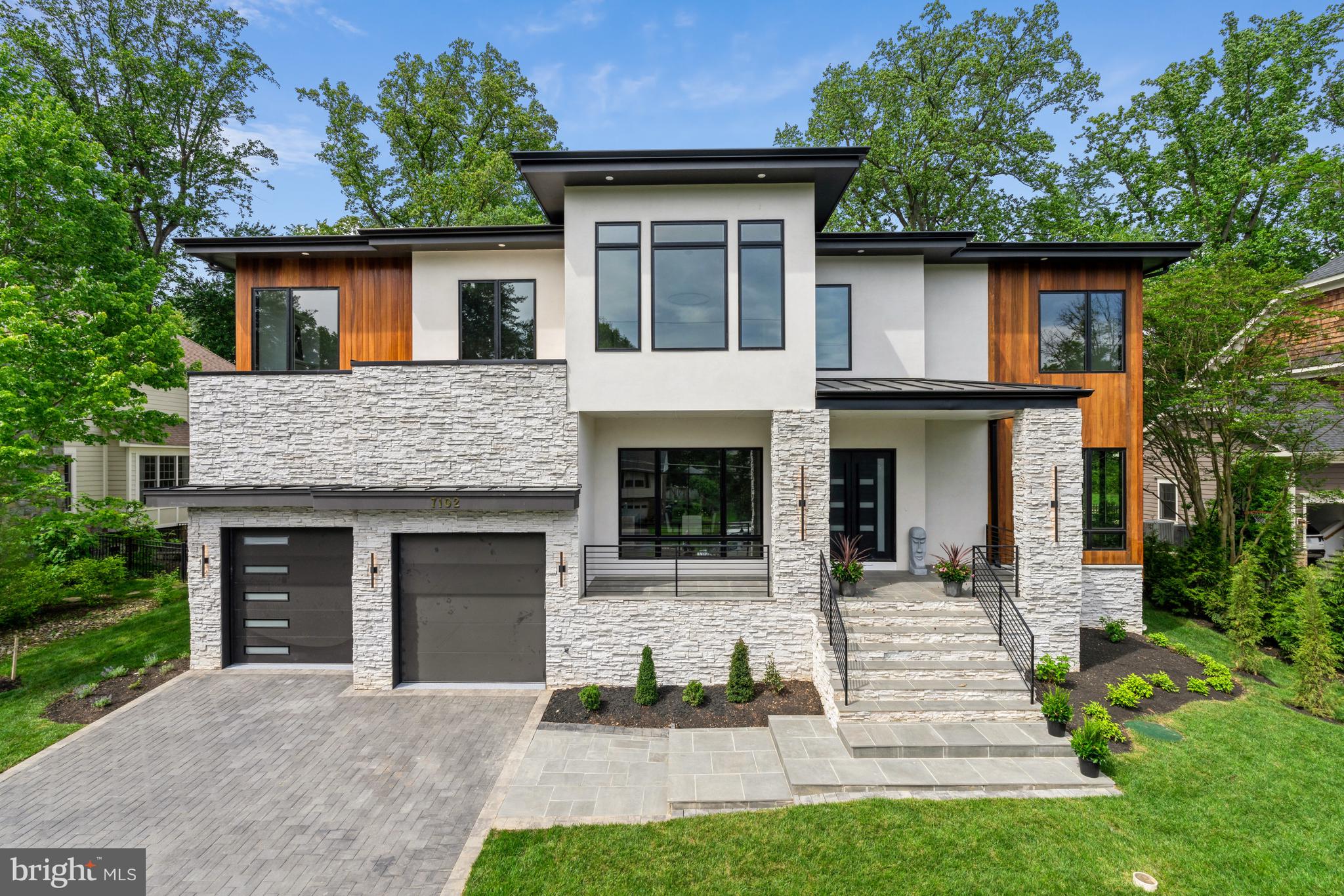 Recently completed, this new construction by The Green Building Group features over 12,000 square feet of exquisite architecture and cutting-edge technology in the highly sought-after Hansborough neighborhood. Upon entering through the custom Avant Iron entry door, you'll find yourself in the stunning foyer that leads to the dining room and a sumptuous office. The family room showcases a linear gas fireplace, Italian book-matched porcelain slab, and floating shelves.  A chef's kitchen, boasts top-of-the-line appliances, a 10-foot quartz island, and modern slab cabinets. A spacious pantry is equipped with a sink, dishwasher, deep drawers, quartz countertops, and ample shelving. The main level also features a private bedroom with a full bath, two powder rooms, and a convenient mudroom. A stunning floating staircase leads to the upper-level sitting area, opening to a Trex deck overlooking the backyard. The owner's suite offers a sitting room with a coffee bar, complete with a fridge and sink, and access to a private screened yoga balcony. The luxurious bathroom features dual vanities, a dual shower, and a freestanding tub. Two custom walk-in closets come with a makeup desk, an oversized LED mirror, a bench, and a central island with multiple drawers.
The upper level also boasts three ensuite bedrooms and a laundry room. The fully finished lower level includes a recreation room with a wet bar, a fitness room, a theater, a cedar sauna, and two bedrooms with full baths. Outdoor living is a delight with a fully fenced, flat backyard, a covered porch with phantom screens, an outdoor gas fireplace, and Cumaru ceilings. The attached two-car garage includes an EV charger and an option for a car lift. The property is elevator-ready and includes an irrigation system that can be controlled via smartphone. Located in the Langley High School pyramid and just minutes from Tysons, Clemyjontri Park, downtown McLean, and within walking distance of schools, the library, and McLean Central Park, this property perfectly balances convenience and luxury.