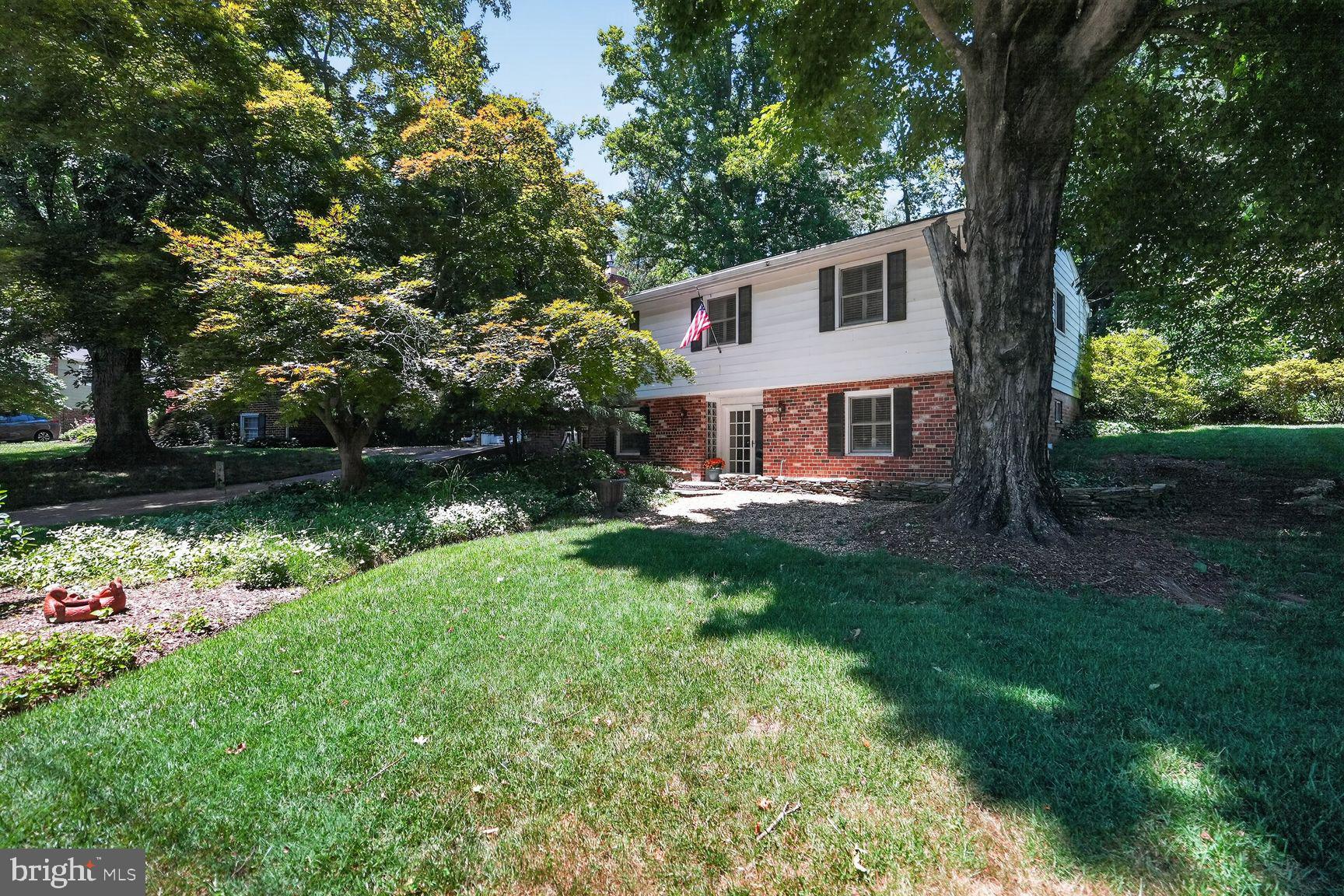 Welcome to this beautifully expanded home in North Bethesda’s highly sought-after White Flint Park! Tucked away on a quiet, cherry-tree-lined street with lush green yards, this rare NO-HOA property offers peaceful suburban living just minutes from city conveniences. An inviting walkway, framed by charming flower beds and a stone wall, guides you into a spacious, tiled foyer with ample closet space for owner and visitors. The entry level is designed for maximum flexibility. Relax in the cozy family room, highlighted by exposed wood beams and a striking gas fireplace with stately mantel and hearth. Adjacent to the family room is a fantastic bonus space with soaring ceilings, hardwood floors, a built-in loft, and a private entrance off the driveway—perfect for a home office, gym, or guest studio. Also on this level is a sprawling bedroom suite featuring a large closet and French doors that open into a bright sitting, craft, or hobby room with built-in bookcases. A large laundry room, a convenient half bath, and excellent under-stairs storage complete the ground floor. Ascend the stairs to discover gleaming hardwood floors and an expansive, light-filled living and dining area. Down the hall, the primary suite offers a private en-suite bathroom and custom-built closet systems, accompanied by an additional bedroom (also featuring built-in closet storage) and a full hall bathroom. The chef-inspired kitchen looks out on to the backyard. It boasts wrap-around butcher block counters, a gas stove, stainless steel appliances, and newly painted cabinets, added custom cabinetry smartly designed to accommodate taller appliances and display your favorite kitchenware. A pantry and generous under-counter space ensure storage is never an issue. Step through the kitchen's sliding glass doors into your spectacular, triple-section outdoor oasis! Entertain with ease using the dedicated stone-floored grilling area, relax under the covered pergola, or soak up the sun on the open deck. The deep, exceptionally private backyard features natural boundaries, providing an exclusive and serene setting for family and friends. Location is Supreme: Leave the car at home! You are within walking distance of two Red Line Metro stations, the Garrett Park MARC train, bus routes, the world-renowned Strathmore Music Hall, and local parks and bike paths. Enjoy having the vibrant dining and at Black Market Bistro in Garrett Park, shopping and dining at Pike & Rose. Minutes commute from NIH, and Walter Reed plus advantageous access to I-495, I-270, and major commuter routes into Washington, D.C. Furnace and A/C : 2024, Electric Panel: 2021 update sensors for fuses connected to phone, Roof: 2012 (25 year transferable warranty). Updated windows adorned with interior wooden shutters.