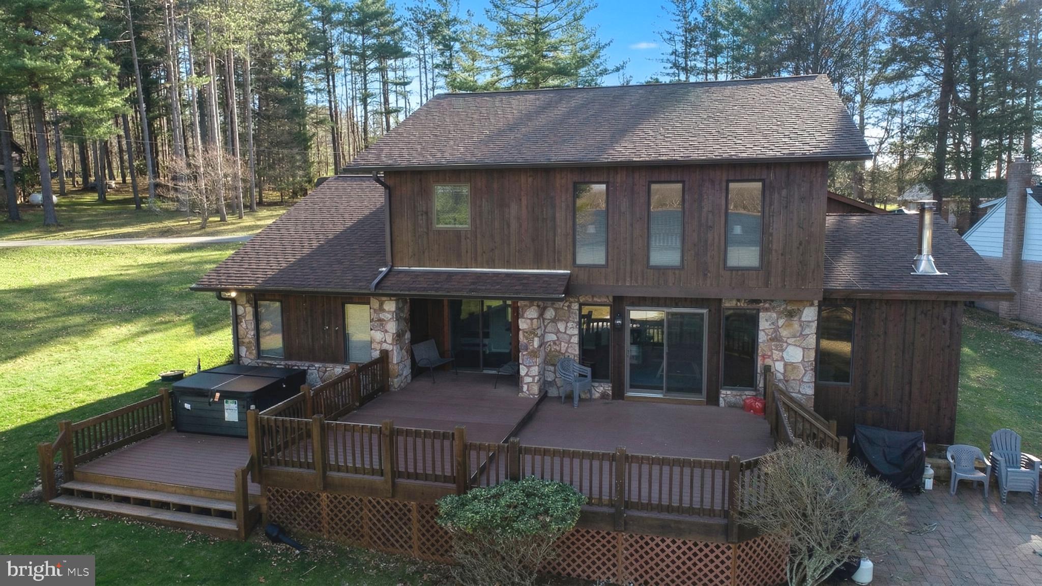 The perfect spot on Deep Creek Lake if you're in the market for a home with spectacular lake frontage,  exceptional views,  and the added bonus of excellent rental potential.    The recently updated 6 bedroom 4.5 bath home  is located near the end of a cul-de-sac on a quiet, yet open cove offering one of the most unique settings on the lake.  The lake frontage is shielded from the effects of heavy boat traffic by two islands  that essentially protect the shoreline and dock area.  

Recent updates include expanded kitchen, and dining areas, multiple primary bedroom suites, additional living space in the detached oversized garage,  outdoor decking , an added lakeside patio., updated HVAC and sprinkler system in the main house structure. 

Virtually all the rooms in the house offer plenty of natural lighting with many offering great lake views.  The oversized type A dock is perfect to relax on at any time of day.  The lakeside of the house features a generous play area for children while the deck, patio and hot tub all offer inviting views of the lake and distant horizon. 

Additional benefits of the property include easy convenience to area restaurants, services, state parks, golf and amenities.  Many are located within 5-10 minutes of the property.   

It all adds up to a great opportunity.  Schedule your appointment today.