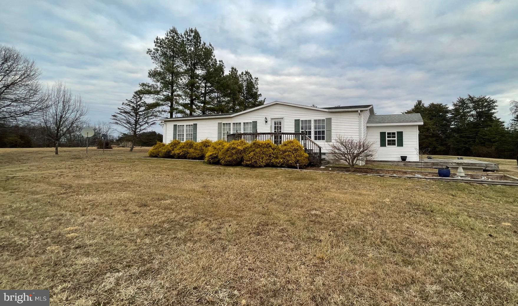Call now to see this very lovely doublewide manufactured home on 2 acres located in the Pleasant Dale Acres. This home has 3 bedrooms, living room, kitchen/dining area, 2 bathrooms, an office or other use. On one end is an addition which can be used for storage or maybe a hobby area. There are 2 sheds in the back yard for extra storage. The acres are flat and boast a beautiful mountain view. Enjoy watching the constellations , stars, moon ,satellites and shooting stars on a clear night  from your side deck. Sit on the back porch and watch the animals come in the yard . Move to West Virginia and become a Mountaineer.