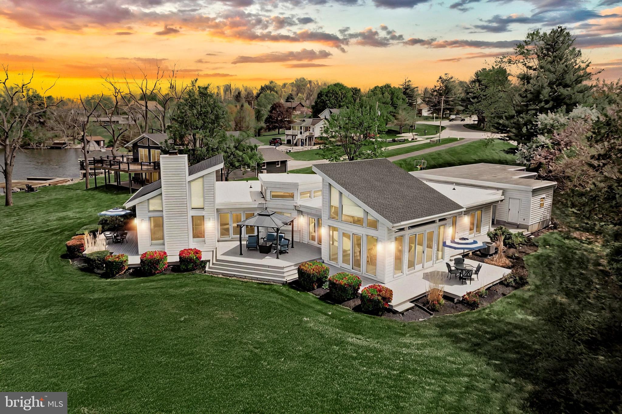 ✨ Where Waterfront Dreams Begin – Lovely Lake Meade Living ✨

Introducing a truly iconic residence—a masterpiece of lakeside living nestled within the prestigious, gated community of Lake Meade. Perfectly positioned on one of the finest waterfront lots in the neighborhood, this custom-built contemporary home offers unparalleled 180° panoramic lake views and over 2,200 sq ft of immaculately curated interior space designed for discerning buyers. This is more than a home—it's a way of life—a rare opportunity to own one of Lake Meade's most admired properties. Private tours are available by appointment only.

Whether you're seeking a serene full-time sanctuary or a showstopping weekend retreat, this 4-bedroom, 2.5-bath home delivers elevated living at its finest.

Step through the front door and experience the air of sophistication—a soaring open-concept layout graced with vaulted ceilings, transom windows, and rich, cedar-stained gray hardwood floors that evoke a chic nautical aesthetic. The heart of the home is the great room, anchored by a beautiful fireplace and flanked by two expansive, ceiling-to-floor windows that seamlessly blur the lines between indoor elegance and outdoor bliss.

Savor sunrise coffees and sunset wines from multiple open-air and covered decks, or relax to the tranquil rhythm of the lake, visible from 7 of 8 rooms in the home. Even in off-season drawdowns, the home's strategic orientation ensures the water remains your daily backdrop.

The upgraded kitchen is a dream, showcasing white cabinetry, gleaming granite countertops, stainless steel appliances, a generous center island with breakfast bar, and a pantry—ideal for hosting everything from spontaneous lake gatherings to elegant sunset dinners.

The owner's suite is a private retreat, complete with direct deck access and a spa-inspired en-suite bath featuring dual vanities,  a soaking tub, and a beautifully tiled walk-in shower. Three additional bedrooms—each with deck access and picture-perfect views—offer ample space for family or guests. A flexible bonus room is ideal for a home office, den, or creative studio, with stunning water views to inspire you every moment.

Outside, this property is fully optimized for the lake lifestyle:
• Three floating docks with two boat slips
• Aluminum boat lift with electrical service
• Wraparound walkways and complete decking
• Oversized two-car garage plus separate garden garage & workshop
• Maintenance-free white rubber roofing and recent upgrades including: new shingle sloped and rubber garage roofs, resurfaced driveway, remodeled primary bath, plush new carpeting, and a spacious laundry room

Additionally, a complete, unfinished crawl space offers extensive storage potential.
Nature lovers will be enchanted by daily visits from bald eagles and herons hunting for fish, and other local wildlife—truly a private paradise.

🌊 About Lake Meade:
This 300-acre lake features over 5.8 miles of shoreline and a vibrant, year-round recreational lifestyle. Enjoy waterskiing, wakeboarding, kayaking, paddleboarding, swimming, and fishing for bass, walleye, crappie, and more. Community amenities include:
• Lakeside pool complex with waterslide & zero-entry zone
• 10 lake access points with docks, playgrounds & picnic spots
• Sports complex with courts and playing fields
• Full-service marina and boat launches
• Iconic 4th of July fireworks over the water
• On-site fire & EMS for peace of mind

Private tours are available by appointment only. Lender's Pre-Approval or proof of funds must be submitted to LA before all showings.
