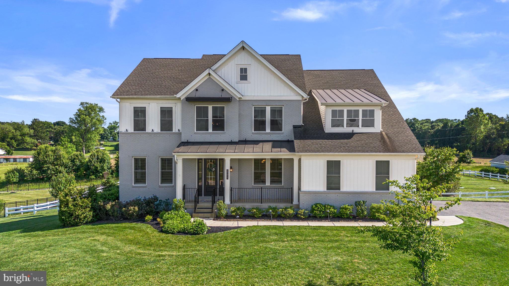 Situated on a picturesque one-acre lot with scenic views, this exceptional home blends custom craftsmanship with luxurious indoor and outdoor living. Rich hardwood flooring, crown molding, exposed beams, modern fixtures, and custom shelving create a warm yet refined atmosphere throughout. The gourmet kitchen is designed to impress with high end appliances, Calacatta quartz countertops, premium finishes, ceiling-high Timberlake cabinets and abundant space for gathering and entertaining. A main-level bedroom suite offers flexibility for guests or multigenerational living. Upstairs, spacious bedrooms provide comfort and privacy, while the stunning primary suite features walk-in closets, a spa-inspired bath with a soaking tub and Kohler digital shower interface and a rainfall showerhead. The finished basement expands the living space with a wet bar, making it ideal for recreation and entertaining. Outdoor amenities are equally impressive, including a screened porch with a gas fireplace, a Trex deck, and a fully equipped outdoor kitchen featuring a built-in stone grill, refrigerator, and wood-burning oven. A four-zone Ecobee HVAC system enhances year-round comfort across this remarkable property.