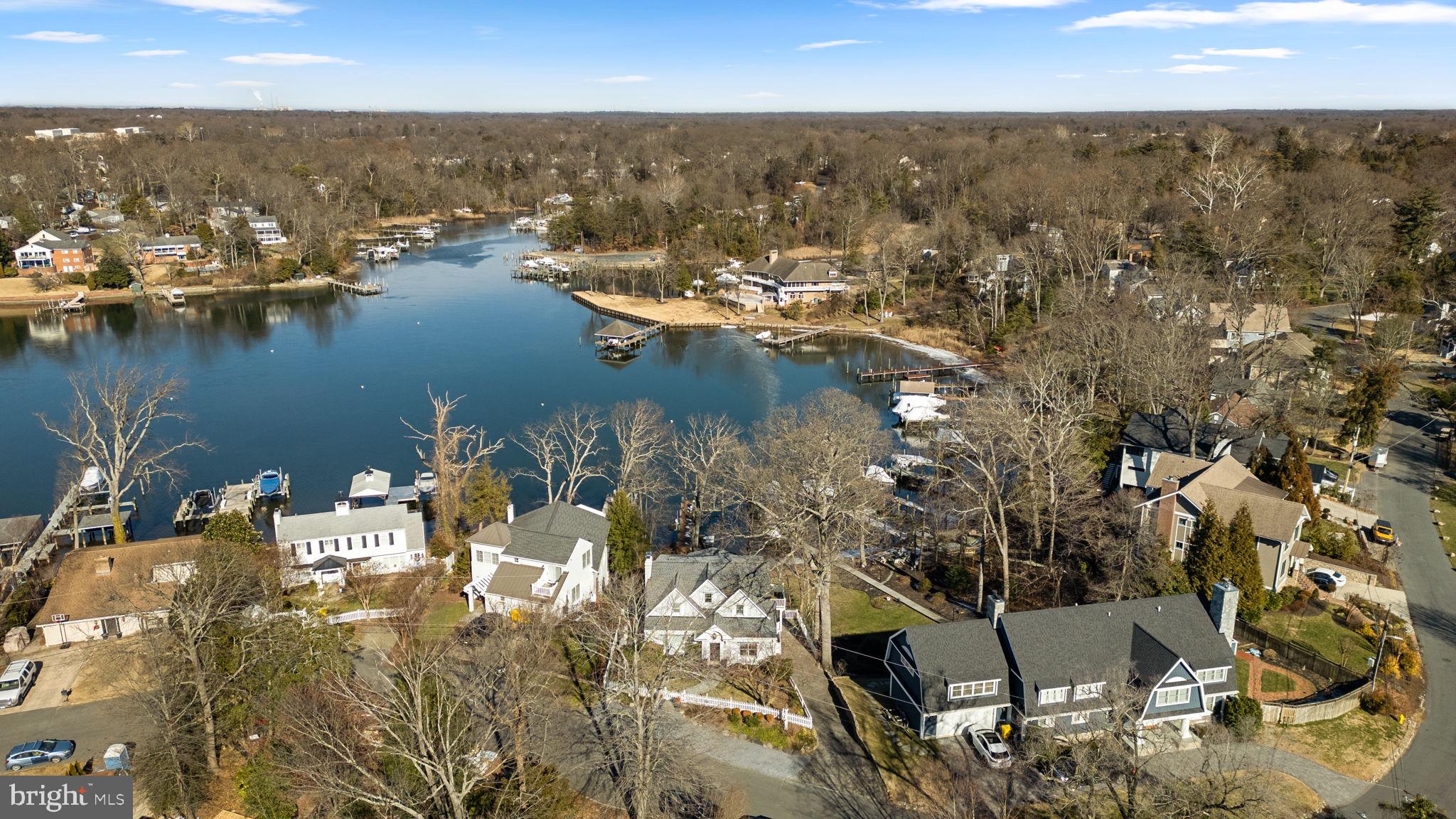 Welcome to this charming Cape Cod waterfront home in the heart of Linstead on the Severn, where classic coastal character meets bright, open living. Thoughtfully renovated in 2016, the home showcases custom finishes and inviting spaces designed to flow seamlessly from room to room, all framed by peaceful water views that define relaxed waterfront living. The main level welcomes you with a cozy seating area and fireplace, leading into an open living and dining space featuring vaulted ceilings, beautiful hardwood floors, and walls of windows that capture sweeping views of Yantz Creek. The chef’s kitchen is both stunning and functional, offering custom cabinetry, a striking backsplash, quartz countertops with a large island, a La Cornue gas range, and a sun-filled breakfast nook. Upstairs, you’ll find three bedrooms and two full bathrooms, including a luxurious primary suite with a marble double vanity, soaking tub, glass-enclosed shower, and walk-in closet. A fourth bedroom or office on the main level, with an adjacent full bath, provides flexible living options. The finished lower level adds a recreation room with a third fireplace, full bath, and laundry room, plus access to the two-car garage with EV charging. Step outside from this level to the covered walk-out patio for effortless indoor-outdoor living. Waterfront features include a private pier with approximately 5' MLW, a 20,000-lb boat lift, and jet ski lift, and boathouse with rooftop deck ideal for entertaining and boating enthusiasts. Enjoy Linstead’s sought-after community amenities, including private beaches, pier, pavilion, playground, and year-round events, all within the Severna Park school district and convenient to major commuter routes. This is a rare opportunity to experience waterfront living at its finest—schedule your private tour today!