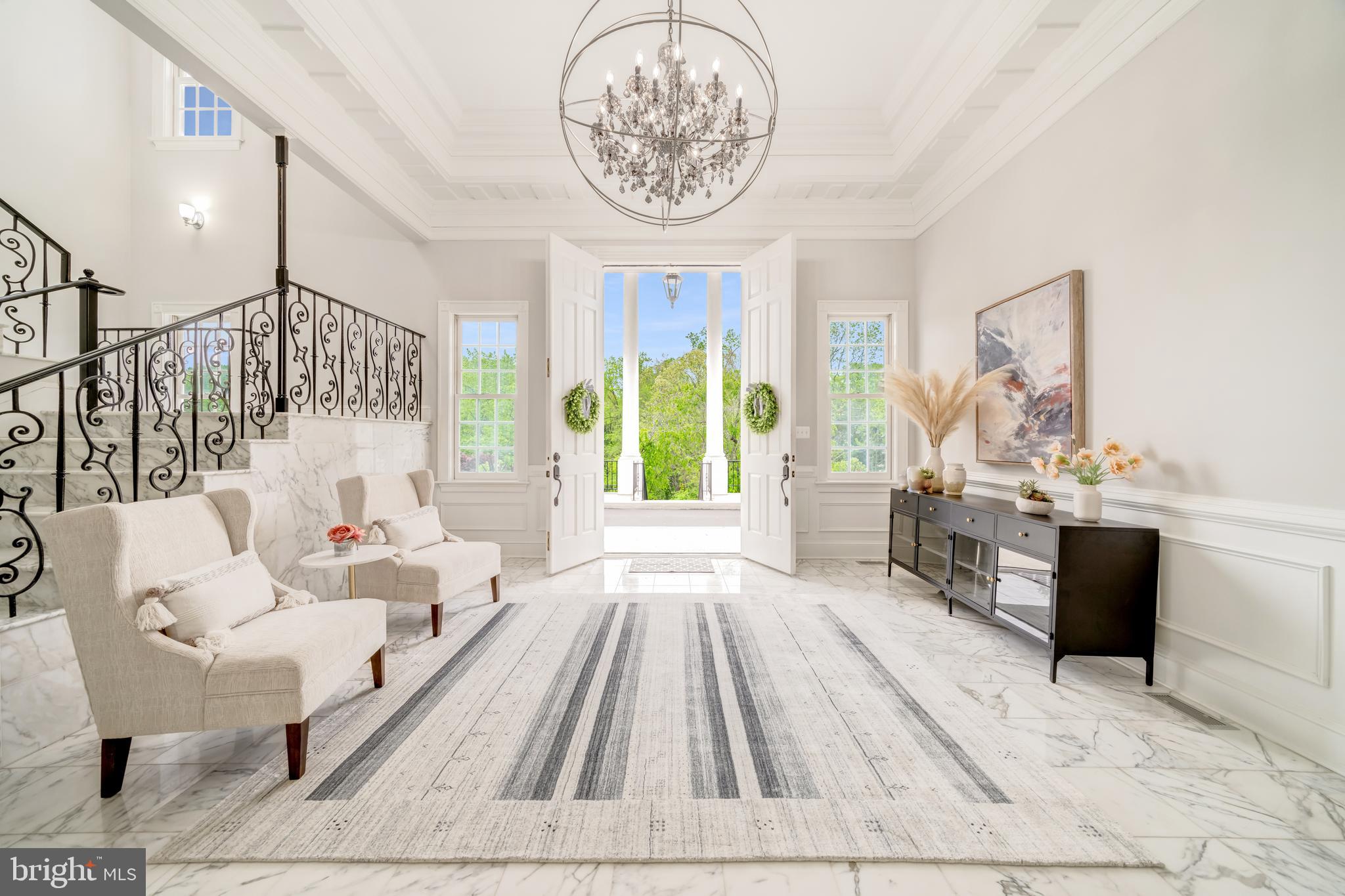 An exceptional opportunity to lease a premier estate awaits in the serene setting of McLean, Virginia, just outside of Washington, DC.  Enter through the private gate and behold this majestic Neoclassical-inspired mansion sitting atop a hill overlooking just over 1.6 acres of lush greenery.  Delight in the Japanese Maples, Dogwoods, and Crape Myrtle trees that gracefully line the two-tiered portico driveway, which provides a path to the dramatic front entrance or around the corner to the three-car attached garage.  The open floor plan of this luxury residence encompasses nearly 13,000 square feet of tastefully designed and fully furnished living space, boasting seven bedrooms, seven full baths and two half baths.  The heart of the home, the striking gourmet kitchen, features top-of-the-line Thermador appliances, and is fully stocked with dishes, cutlery and cooking utensils, offering functionality, convenience, and style.  Immerse in luxury as you enter the grand foyer, which offers a direct sightline through the circular lounge to the rear lawn.  White marble floors adorn the main and lower levels, providing a sophisticated ambiance that perfectly complements the stylish furnishings throughout. With ceilings soaring to 14 feet and adorned with classic moldings, every inch of this home is a feast for the eyes.  A graceful marble staircase leads you to the second level.  Or, if you prefer, take the three-level elevator instead.  On the second floor, fully appointed suites line the hallway, which ends in a dramatic arched window. The primary suite exudes grandeur, featuring a fireplace, and an opulent marble-tiled spa-like bath with rain-shower and separate soaking tub. Each upstairs room offers the convenience of its own en-suite bathroom, ensuring the utmost in comfort and privacy for guests.  The 4,000+ square foot lower level boasts oversized bar for entertaining and a sauna for relaxing.  French doors lead out to a massive flagstone patio, furnished with a lounging area, dining area and grill.  Ideally suited for embassies or executives, the convenient McLean location offers easy proximity to Washington, D.C., Capitol Hill, Tysons Corner, local airports, and other key destinations.  Yet, the home feels miles away from the hustle and bustle of it all, tucked away from the main roads and surrounded by verdant space.  Please note that viewings are available by appointment only and require 24-hours advance notice.  Contact the listing agent to schedule your tour today!