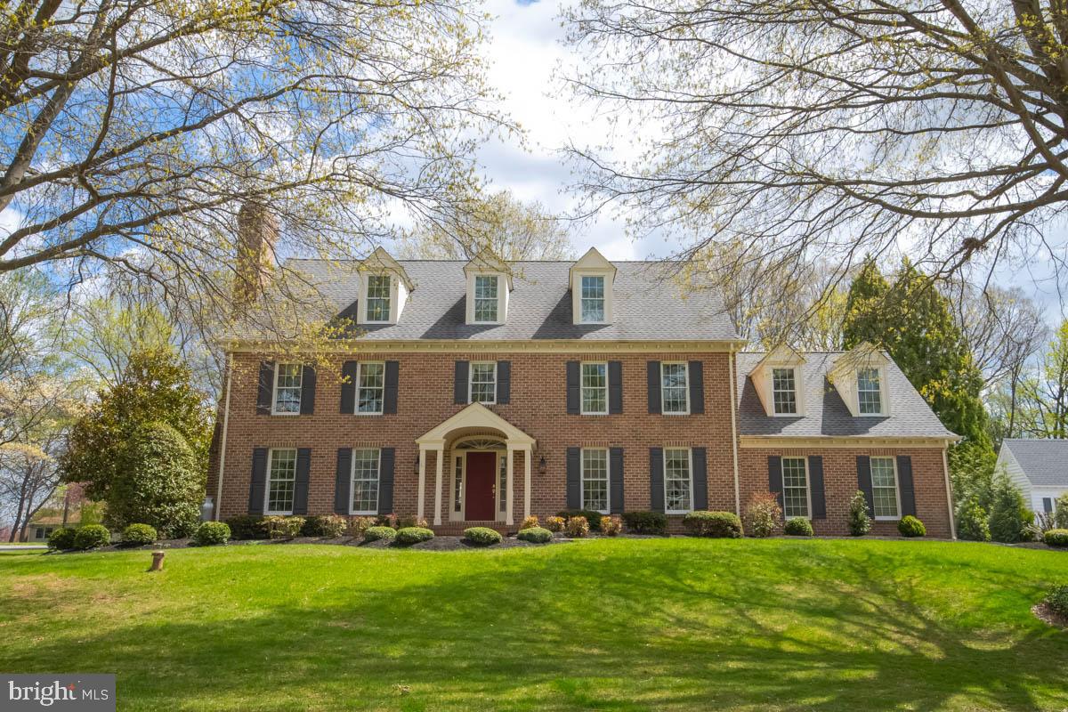 GORGEOUS, custom built Center Hall Colonial offers 5-6 BRs, 3/1 BAs, an oversized 2 Car Garage and is located in the beautiful Strathmoor community! Be transported to your own 'Slice of Heaven' with this stately, all brick home, situated on a slightly elevated hill surrounded by a manicured yard with mature trees. As you walk up the sidewalk, be captivated by the floral landscaping and peaceful neighborhood. Once inside, you'll enter the foyer with hardwood floors, wainscotting, chair rail and where you can enter the home office offering built-in bookshelves, wood floors and French doors and the formal living room offering crown molding, wood floors and a gas (propane) fireplace. From there, enter the formal dining room enhanced by gorgeous views of the patio and back yard, crown molding, wood floors and direct access to the gourmet kitchen and breakfast area which offers stunning cabinetry, high-end Jenn Air SS appliances, a downdraft surface stove (propane), wall oven/microwave that is convection and conventional, built-in secretary desk and granite countertops. The SUN-DRENCHED Great Room with fireplace, wood floors, French doors and crown molding is spacious yet gives a cozy, warm and relaxed feel. From the breakfast area, open the French doors to access the brick patio and large backyard framed by mature trees in rear and flowering bushes/trees on each side... did I say 'Slice of Heaven'? What a great yard for the kids and pets to plays in and large enough to add your own pool!  Back inside, walk up the hardwood staircase enhanced with wainscotting/chair rail to the second floor where you will find 4 BRs and 3 full baths. The large primary suite offers wwc, crown molding and custom window treatments. The spacious updated primary bath offers gorgeous cabinetry, granite countertops, twin sinks, a walk-in shower, soaking /jetted tub, water closet and large walk-in closet.  On the second floor, you'll also find a second bedroom suite with nook, crown molding, wwc, window treatments, and a private 3-pc bath with granite, a walk-in shower, plus a walk-in closet. The two remaining BRs offer wwc, crown molding and window treatments.  One floor up, find the Bonus Room/5th BR which the original owner created as a hobby room and offers ww Berber carpet, loads of storage, walk-in closet, extra storage and window treatments. The worktable conveys with home. Be creative! Make it an office, teen hang-out, an extra bedroom or child's playroom! Across the hall find the second Bonus room (Man Cave!) with wwc, walk-in cedar closet, extra storage behind smaller doors and window treatments which could easily be the 6th BR. The unfinished basement offers built-in equity to you and the opportunity to finish it exactly the way you'd like! SPECIAL NOTE: Windows/screens replaced in 2020 with Anderson Thermopane windows.  Third floor Bonus Room and Game Room add approx. 1,000 SqFt totaling 4,938 total above grade finished space. Original fireplaces were wood-burning and have been converted to propane gas which can be transitioned back to W/B should you choose. The architectural roof is 12 years old with a 15-year warranty. New washing machine installed 10/2024, new D/W and Cooktop installed 10/2020. Refrigerator/freezer in basement conveys. Sellers are graciously offering a Choice One one-year home warranty to the buyer. Truly the perfect, turn-key home in a beautiful community all close to schools, shopping, major highways and APG.