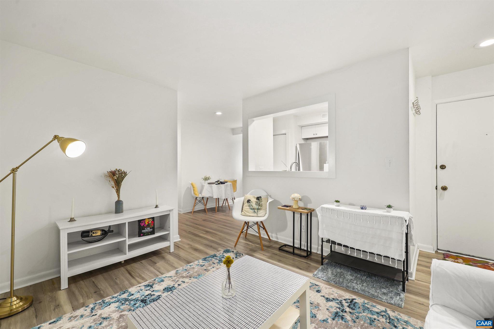 Beautifully updated first-floor condo in a prime Charlottesville location! This move-in-ready 1-bedroom, 1-bath home combines comfort, convenience, and modern finishes. Inside, you'll find luxury vinyl plank flooring throughout, an updated kitchen with stainless steel appliances, and a renovated bathroom with updated fixtures and bathtub. The spacious bedroom features a walk-in closet with custom built-ins for excellent storage.  One of the few units in the community with an in-unit stackable washer and dryer, this condo also offers peaceful tree views and easy first-floor living. Located just steps from the parking lot and community pool, everyday convenience is at your doorstep.  Residents enjoy a well-maintained community where HOA fees cover the pool, exterior and yard maintenance, trash, water, sewer, and ample off-street parking. Conveniently located on a bus route.  Walk to UVA's Law School, Darden School of Business, JAG School, the Rivanna Trail, and Barracks Road Shopping Center with its restaurants, grocery stores, and retail options. A fantastic opportunity in an unbeatable Charlottesville location!,White Cabinets