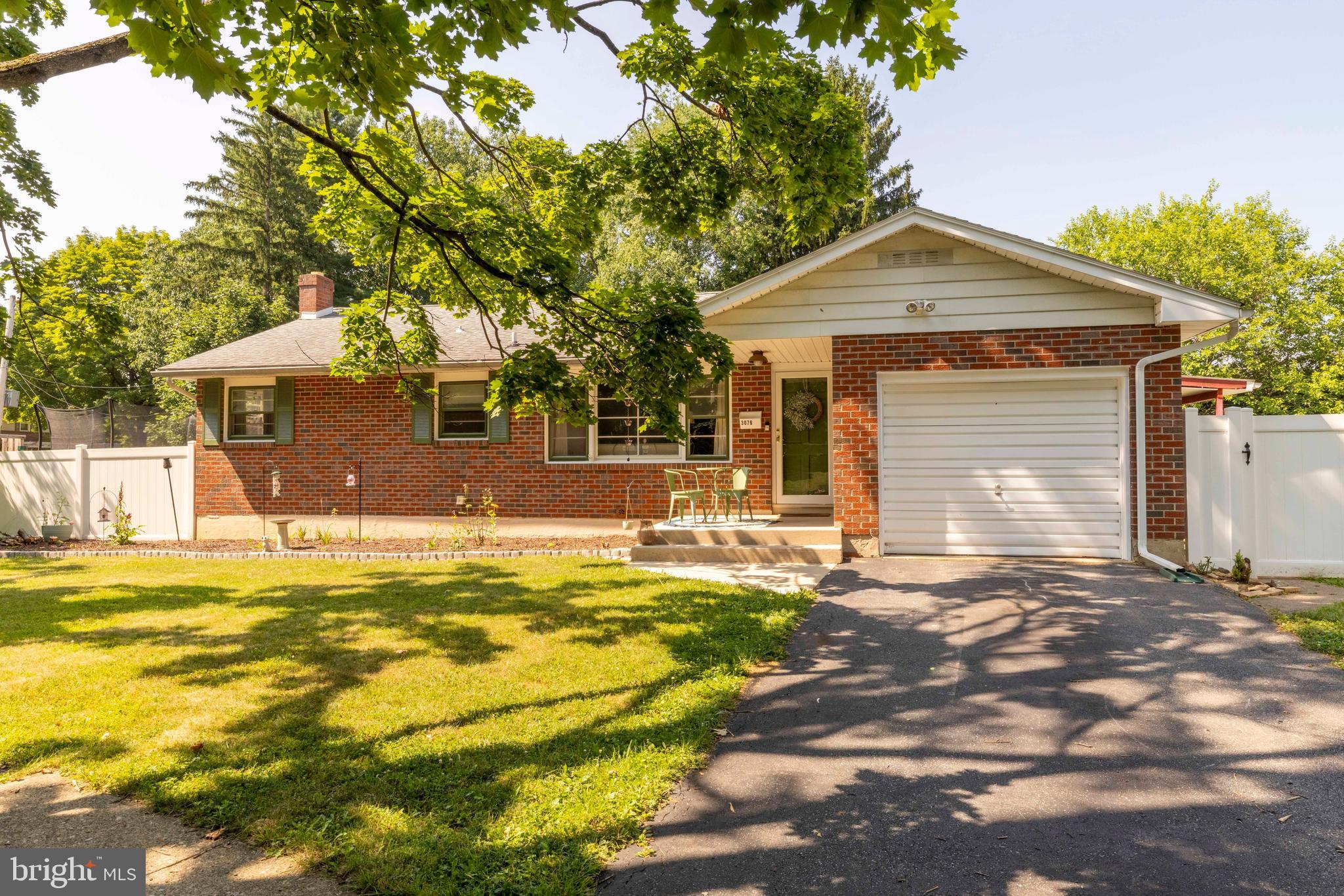 Welcome to this charming brick ranch situated on a corner lot along a beautiful tree-lined street. Whether you're searching for your first home, looking to downsize, or are anywhere in between, this home offers something for everyone. Step inside to a large living room that flows seamlessly into the dining room, creating the perfect space for everyday living and entertaining. Down the hall, you'll find three generously sized bedrooms and a full bath. The spacious kitchen features a door leading to a cozy covered porch, the perfect spot to enjoy your morning coffee or unwind at the end of the day. The lower level boasts a brand-new full bath and a newly finished basement, offering additional living space with just a few finishing touches remaining. Outside, the large, fully fenced backyard provides privacy and plenty of room for outdoor enjoyment. Add your personal style to this charming home and make it your own. Located within walking distance of all three local schools and with easy access to Routes 22, 33, and 78, this home combines comfort, convenience, and opportunity.