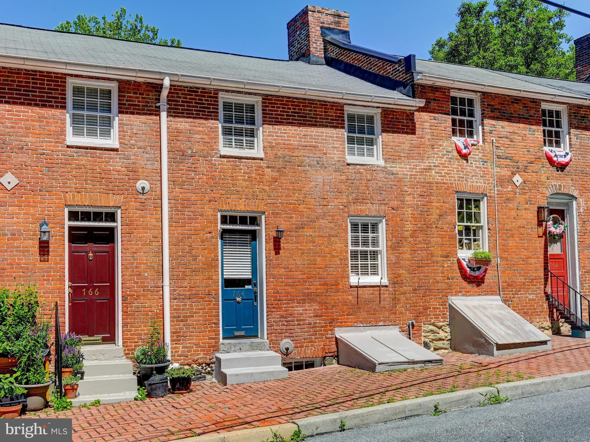 Welcome to 764 Oella Ave!  Welcome home to the heart of the highly sought-after Oella community, where history, charm, and modern convenience come together in perfect harmony.  This rarely available early-1800s brick row home offers a unique opportunity to own a piece of local history while enjoying thoughtful updates designed for today's lifestyle.  Rich character is evident throughout, from the timeless brick construction to the exposed stone accent wall in the main entry. The updated kitchen features floating shelves, ample counter space, and newer appliances, including a dishwasher and oven installed in 2026, while the beautifully renovated bathroom (2022) adds contemporary comfort.  Additional recent improvements include a hot water heater (2025) and washer and dryer combo (2024), providing added peace of mind. The spacious primary bedroom offers an ideal balance of comfort and storage, while the versatile second bedroom or home office is filled with natural light thanks to its motorized skylight cover.  Outdoor enthusiasts will love direct access to hiking and biking trails in Patapsco Valley State Park just behind the home, as well as the nearby Trolley Trail and scenic riverside walk to Historic Ellicott City, where unique shops, dining, and small-town charm await.  Ample parking is found in the community private lot with unassigned spaces for everyone.  Fall in love with the timeless hills of Oella and begin your next chapter in one of the area's most treasured communities.  Opportunities like this do not come available often - Schedule your showing today!