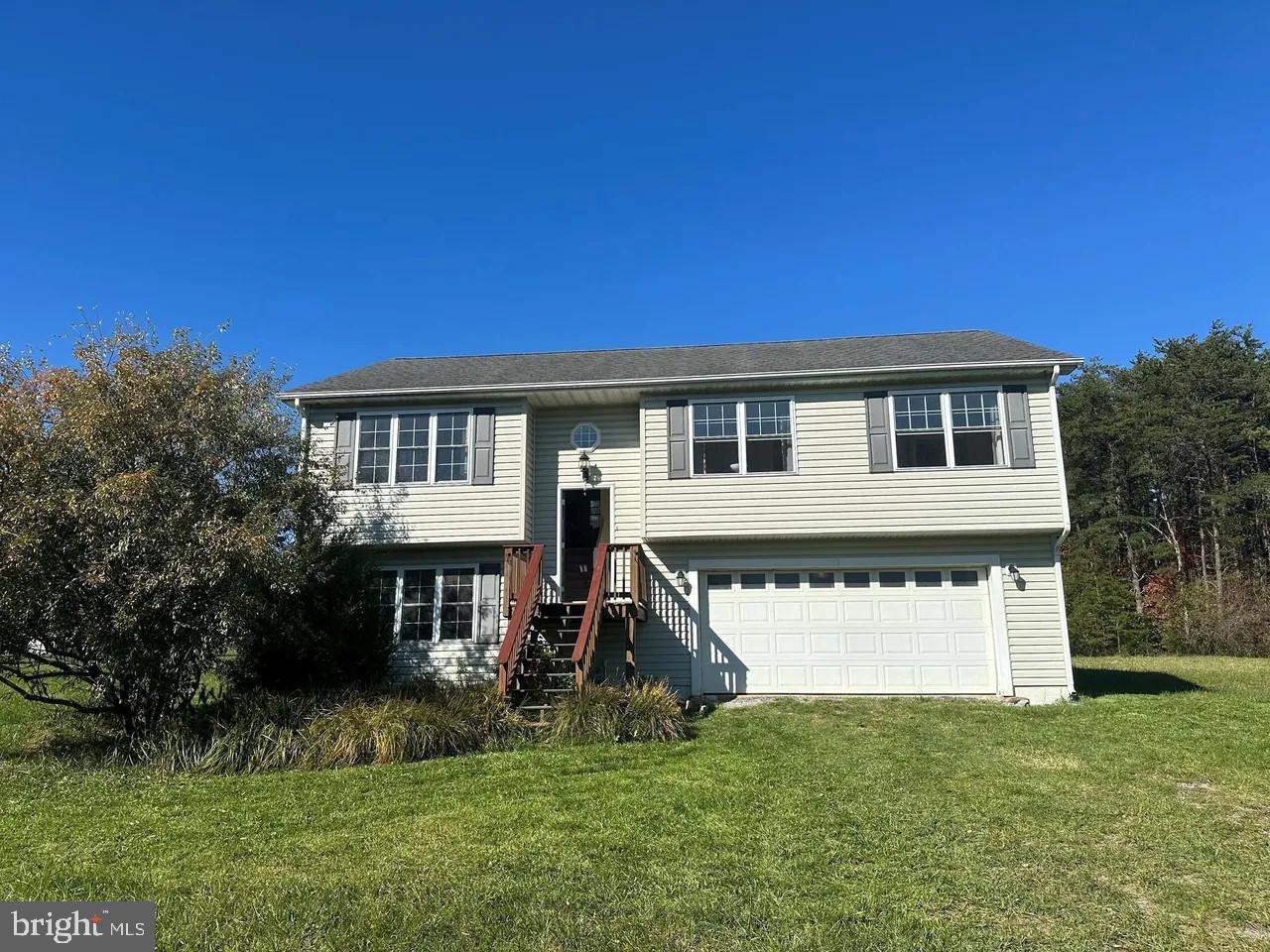 All renovated move-in ready bi-level 4 bedroom 2 full bath house with pleasant views. Large windows, tons of light. 2.2 acres of unrestricted flat lot in desirable commuter location of Southern Berkeley Springs by VA state line, 25min to Winchester. 

New paint, new carpet, new flooring, new light fixtures, new hardware, upgraded appliances, cathedral ceiling,  2 car garage. Finished 1st level with rough-in plumbing for 3rd bathroom. 
Free well water, fast internet connection.